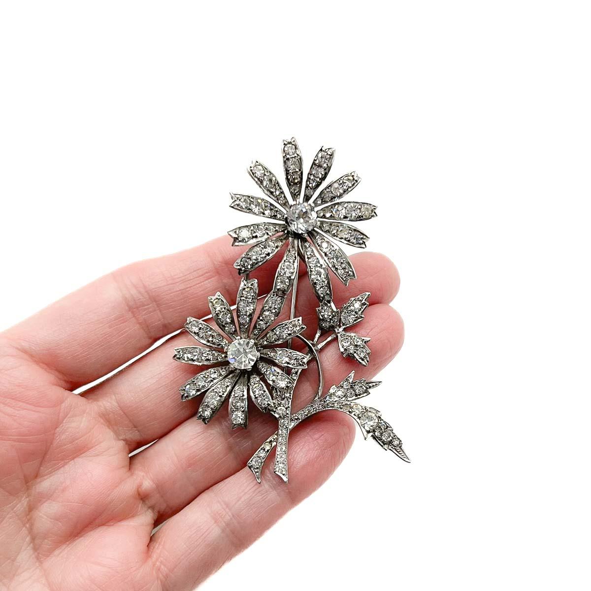 	
A large and truly stunning Art Deco Floral Spray brooch. The Art Deco influence stylising this classic design and giving it a real edge. An all time classic and jewel hero with the look of platinum and diamond (just the look). Exquisitely crafted