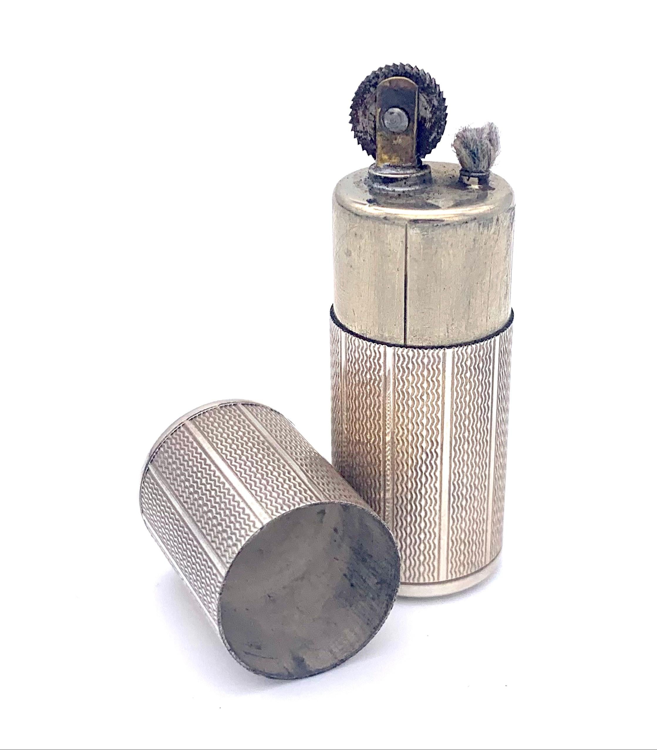 This elegant little lighter will fit into any pocket or small handbag. It was created out of silver in 1920 ca. It has a beautiful engine turned decoration on the outside. It has a silky smooth feel to it and it is lovely to hold in the hand. The