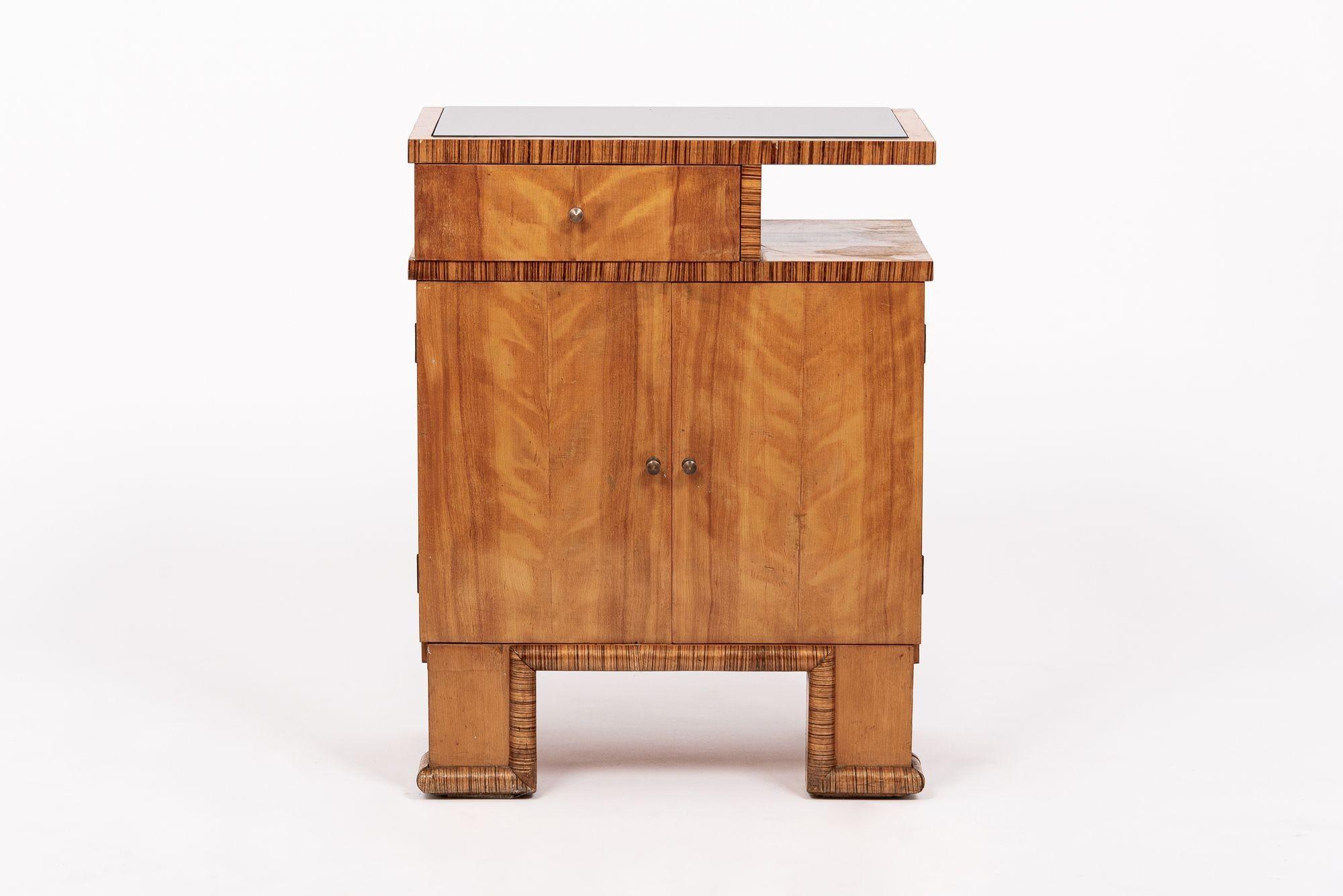 Questo antico mobile bar o credenza in legno e vetro in stile Art Déco risale al 1930 circa ed è probabilmente austriaco. Questo grazioso mobiletto è stato accuratamente realizzato a mano in legno di raso con finiture in legno di zebra e ha una