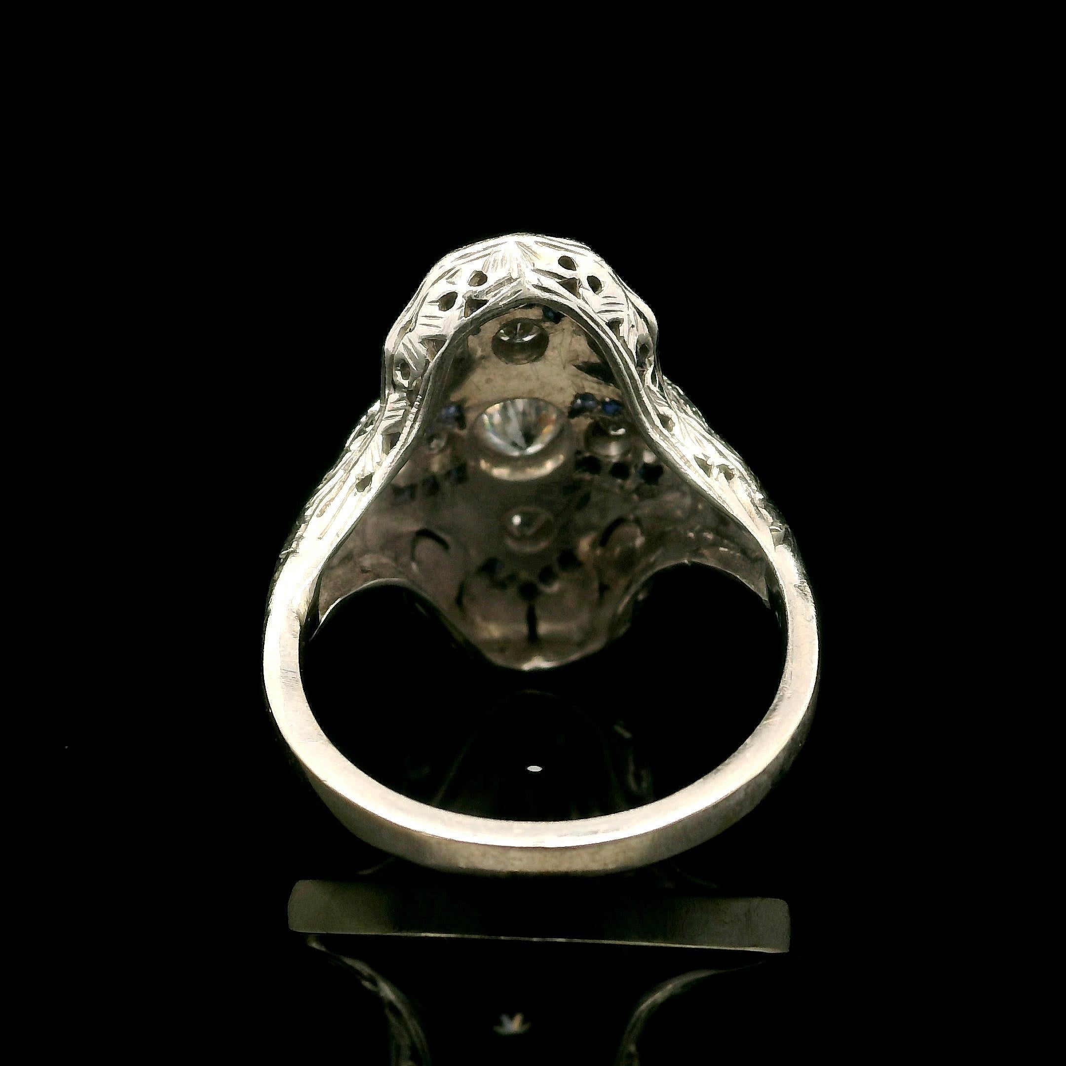 --Stone(s):--
(7) Natural Genuine Diamonds - Old Cut - Pave Set - VS1-SI2 Clarity - G/H Color
(22) Synthetic Sapphires - Calibre French Cut - Channel Set - Blue Color

Material: Solid 18k White Gold 
Weight: 4.46 Grams
Ring Size: 5.5 (Fitted on a