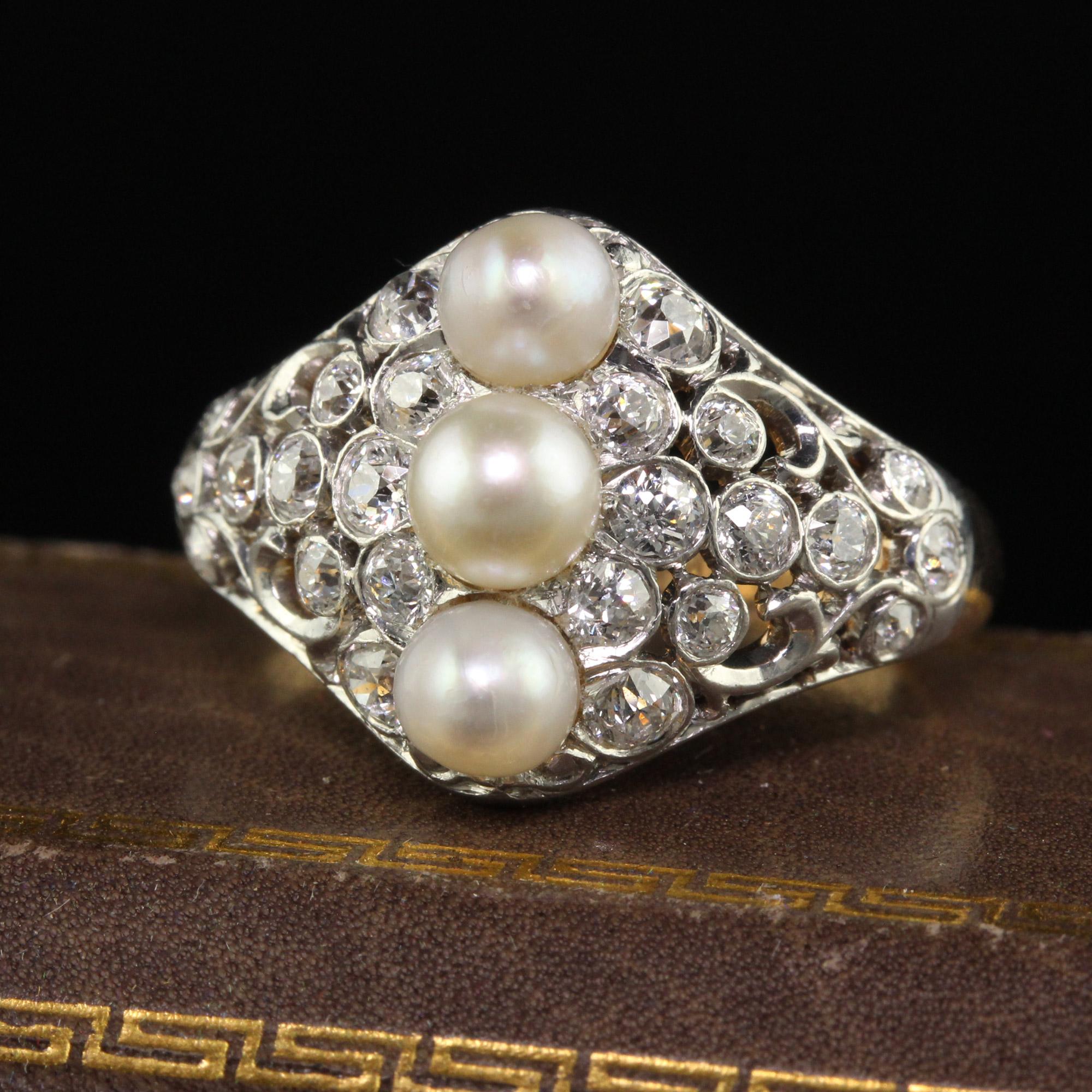 Beautiful Antique Edwardian Spaulding and Co 18K Gold Platinum Old Euro Diamond Pearl Ring. This gorgeous three stone pearl ring is crafted in 18k yellow gold and platinum. The center of the ring has  a row of three natural pearls and is surrounded