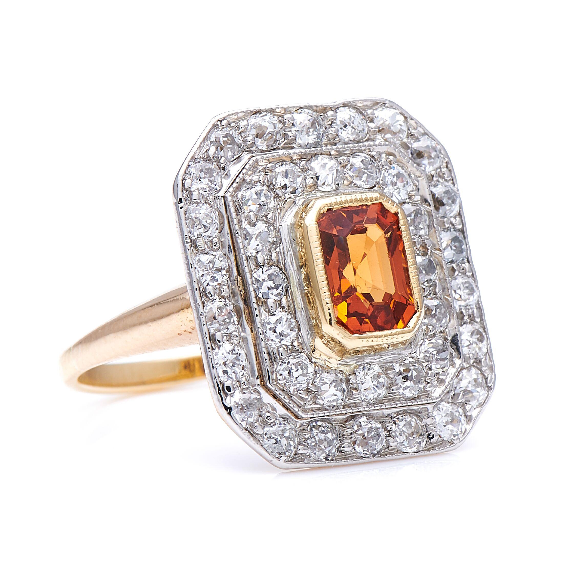 Garnet and diamond ring. This cut-cornered rectangular cluster echoes the cut of the central orange stone, which is a variety of garnet known as Spessartine or ‘Mandarin’ garnet, and is the only member of the garnet family to display this striking