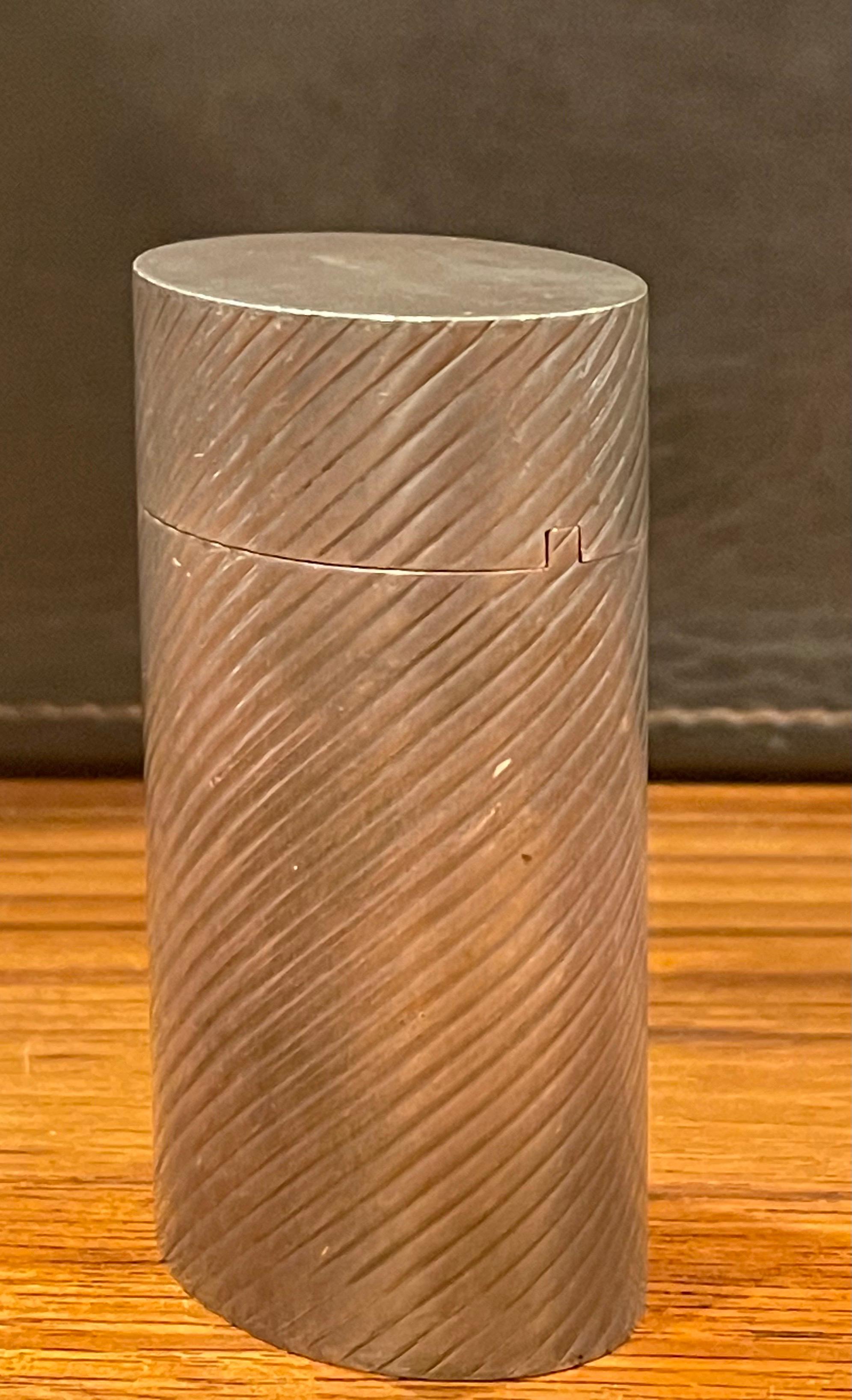 A very rare antique Art Deco sterling silver lidded box by Tiffany & Co., circa 1940s. The piece was mostly likely used for cigarettes or matches, but can be used for trinkets or jewelry. Oval in shape, the box has diagonal lines running the length