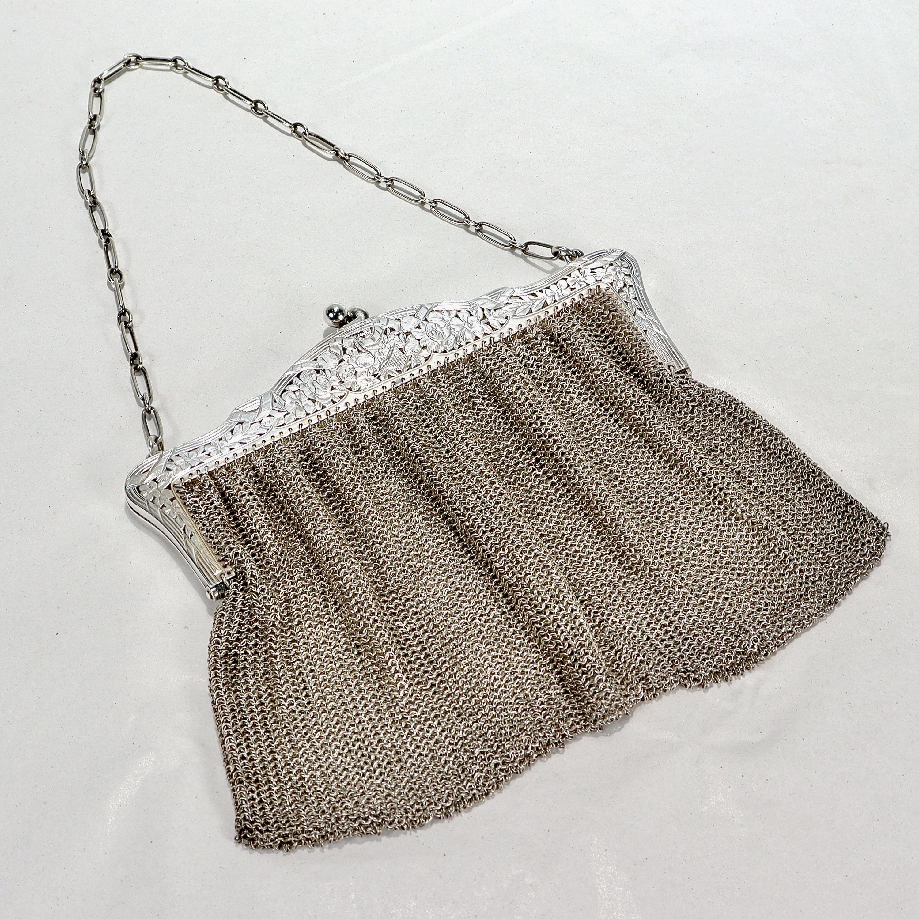 A fine vintage silver mesh purse.

Consisting of a silver mesh divided bag separated by a folding internal arm. 

Supported by an ornate pierced & etched frame & chain link handle.

Simply a wonderful Art Deco sterling silver purse! 

Date:
Early to
