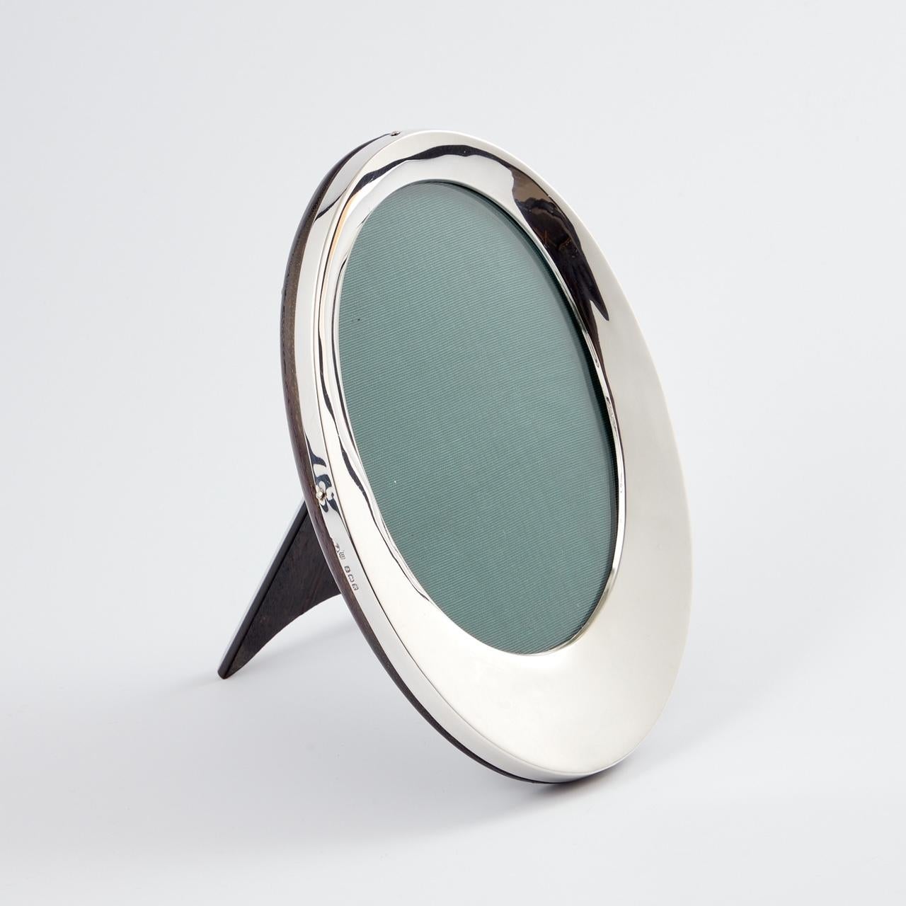Marco para fotografía antiguo Art Déco de plata de ley, fecha Birmingham circa 1924 del fabricante A&J Zimmerman Ltd.

Este inusual marco de plata de forma cóncava está en muy buen estado, sin arañazos ni imperfecciones. 
El respaldo y el puntal