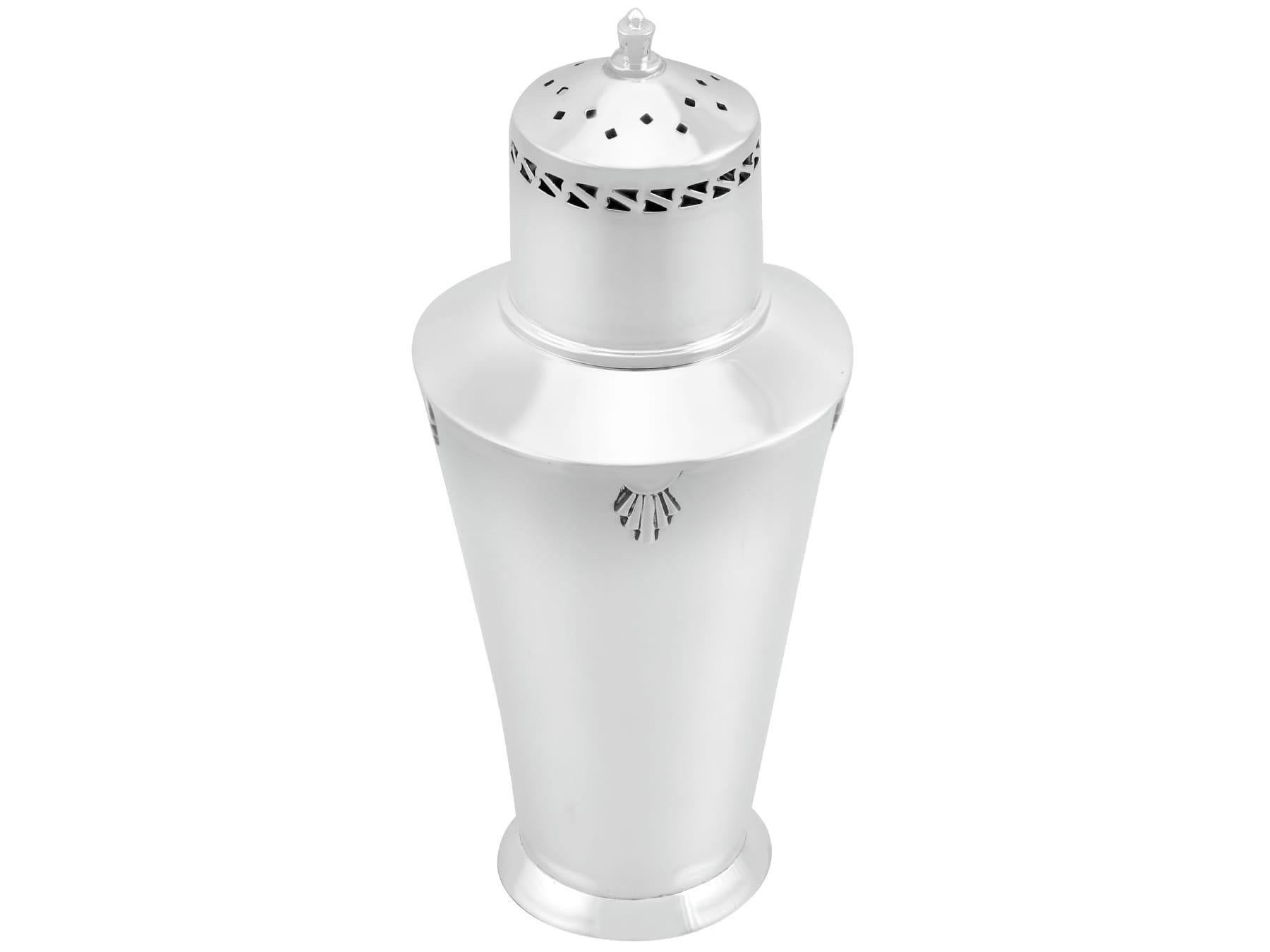 An exceptional, fine and impressive antique George V English sterling silver sugar caster in the Art Deco style; an addition to our silver teaware collection

This exceptional antique George V sterling silver sugar casterhas a tapering cylindrical