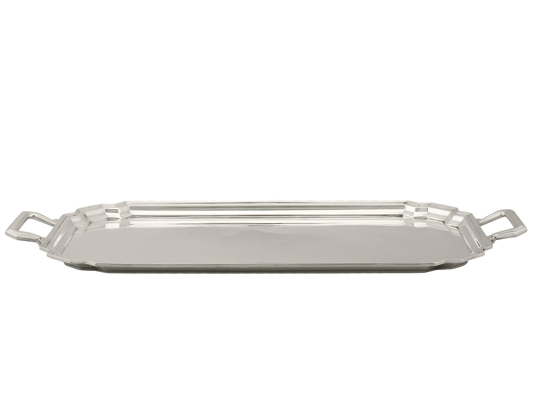 An exceptional, fine and impressive antique George V English sterling silver tray in the Art Deco style; an addition to our range of silver trays, salvers and plates.

This exceptional antique George V sterling silver tray has a plain rectangular