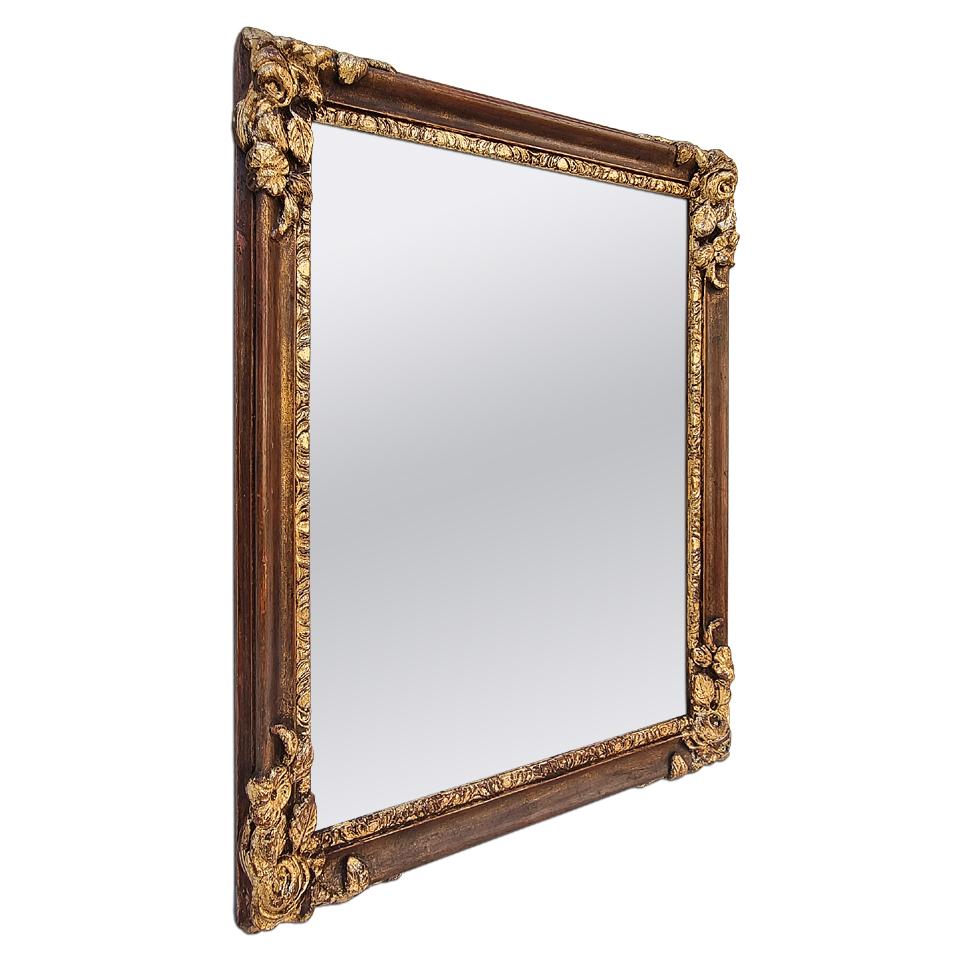 Antique Art Deco style French mirror, circa 1930. Re-gilding to the leaf patinated (Antique frame measures: Width 4.5cm / 1.77 in.). Modern glass mirror. Antique wood back.