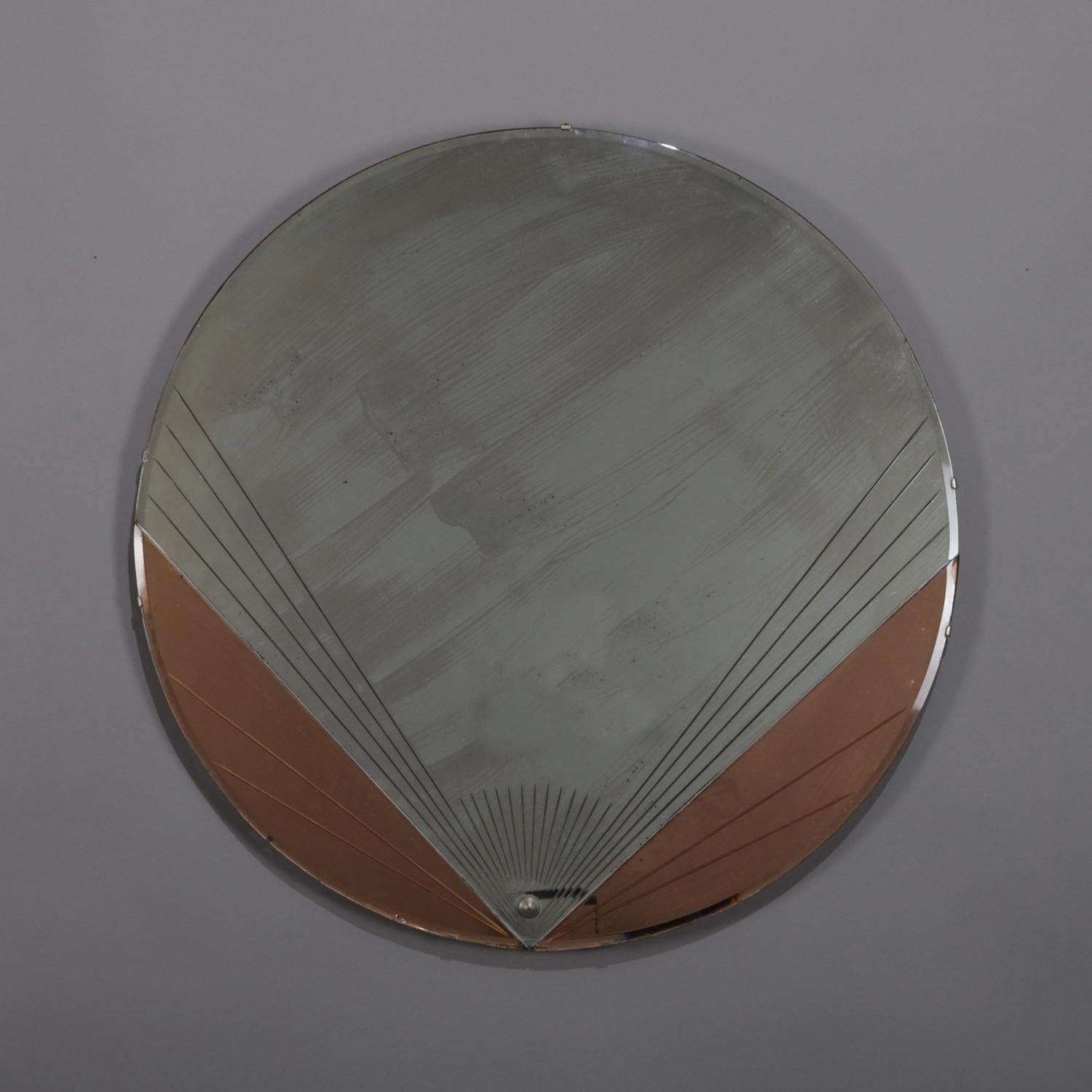 Antique Art Deco wall mirror features circular form with stylized fan in two-toned copper and silver backing, en verso original label, circa 1920

Measures: 28