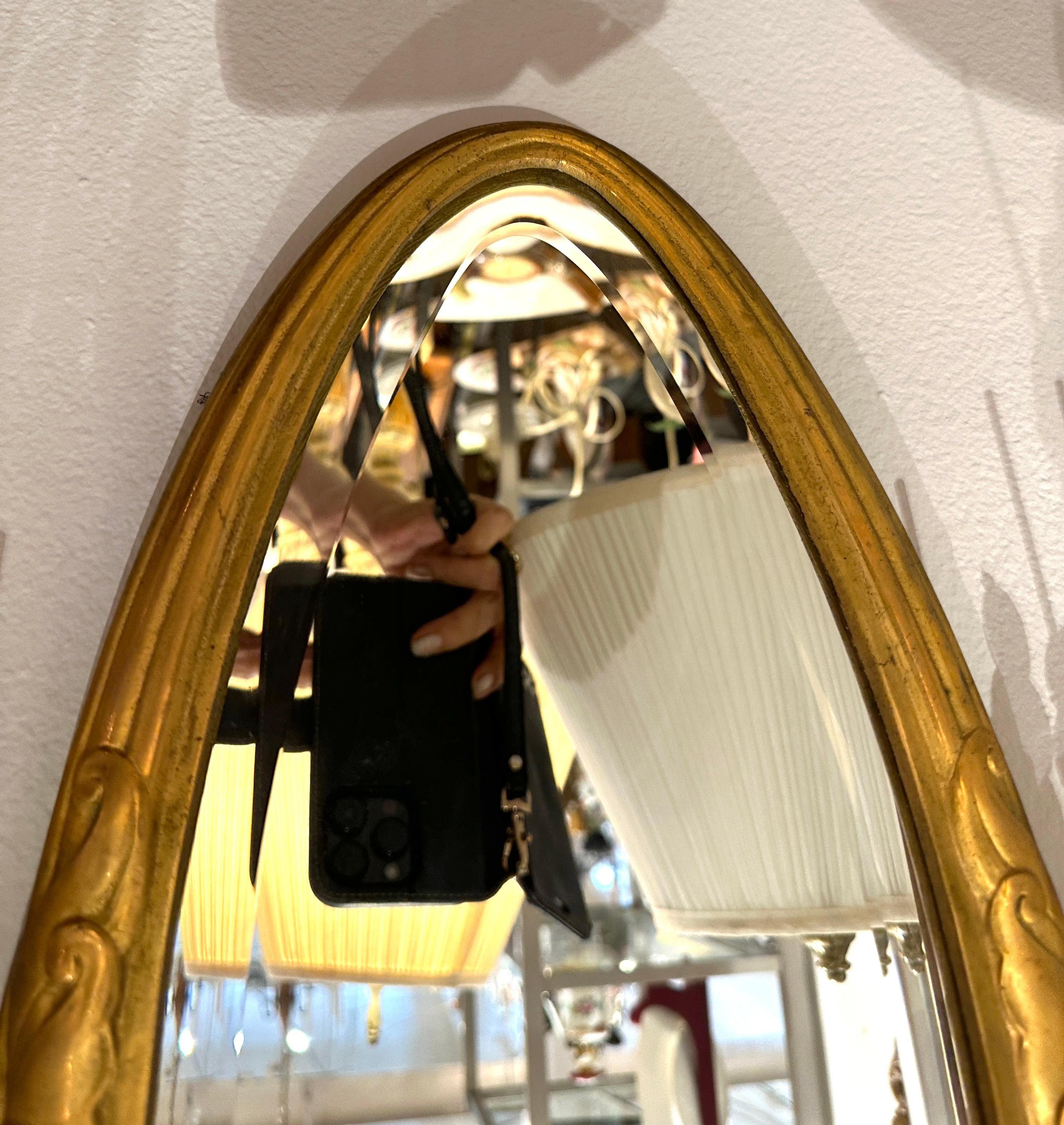 1920s Sue et Mare.  Exceptionally beautiful Gilt bronze oval mirror flanked on sides with glass bead covered down lights.  
Created by French designers Sue et Mare.  
Oval bevel mirrors have been newly replaced, but the original mirrors can be
