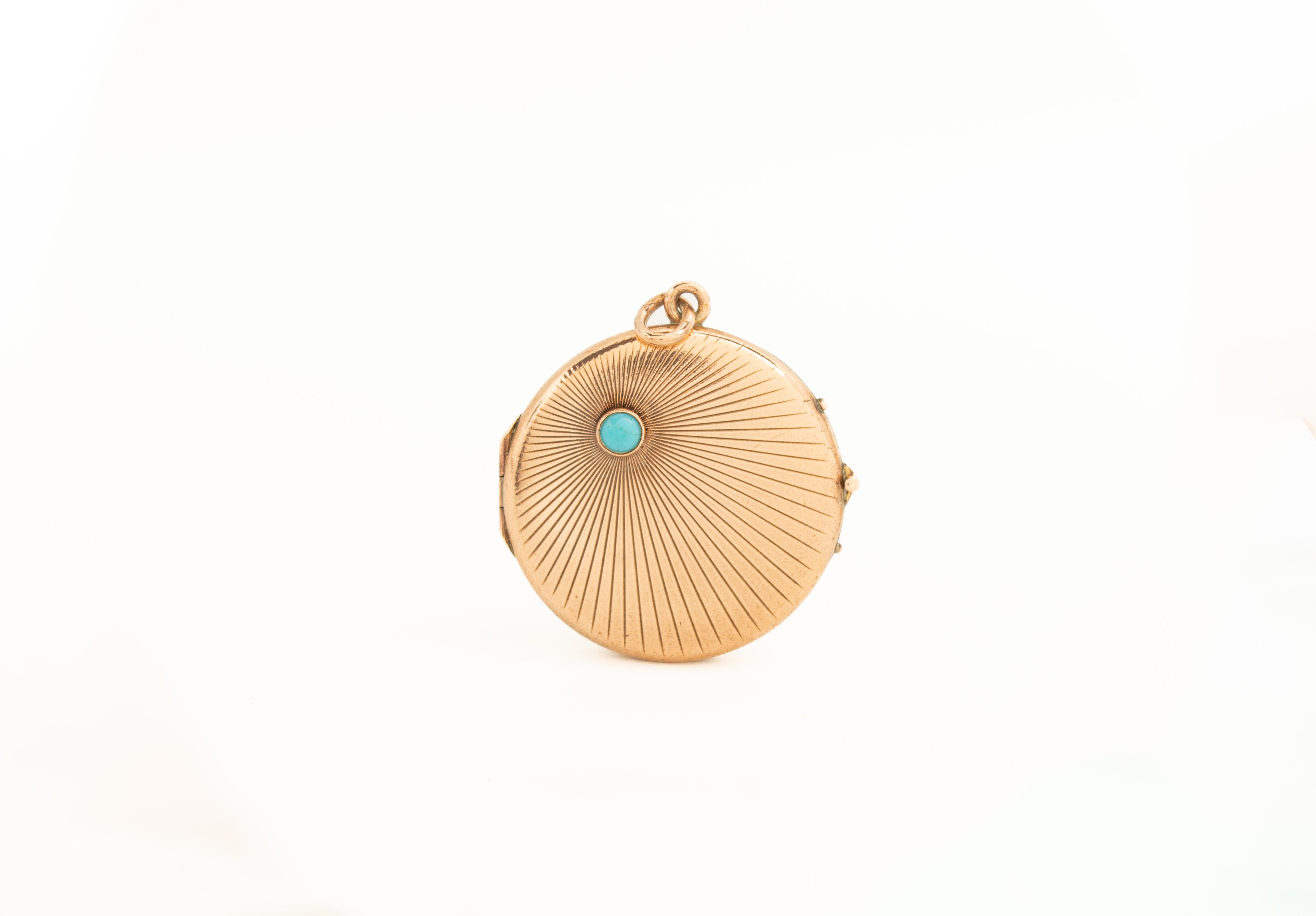 A lovely antique yellow metal circular Art Deco locket with a sunburst design and a natural turquoise gemstone. This locket has typical for the Art Deco era geometric motif with a beautiful turquoise on the top left. The locket opens to reveal two