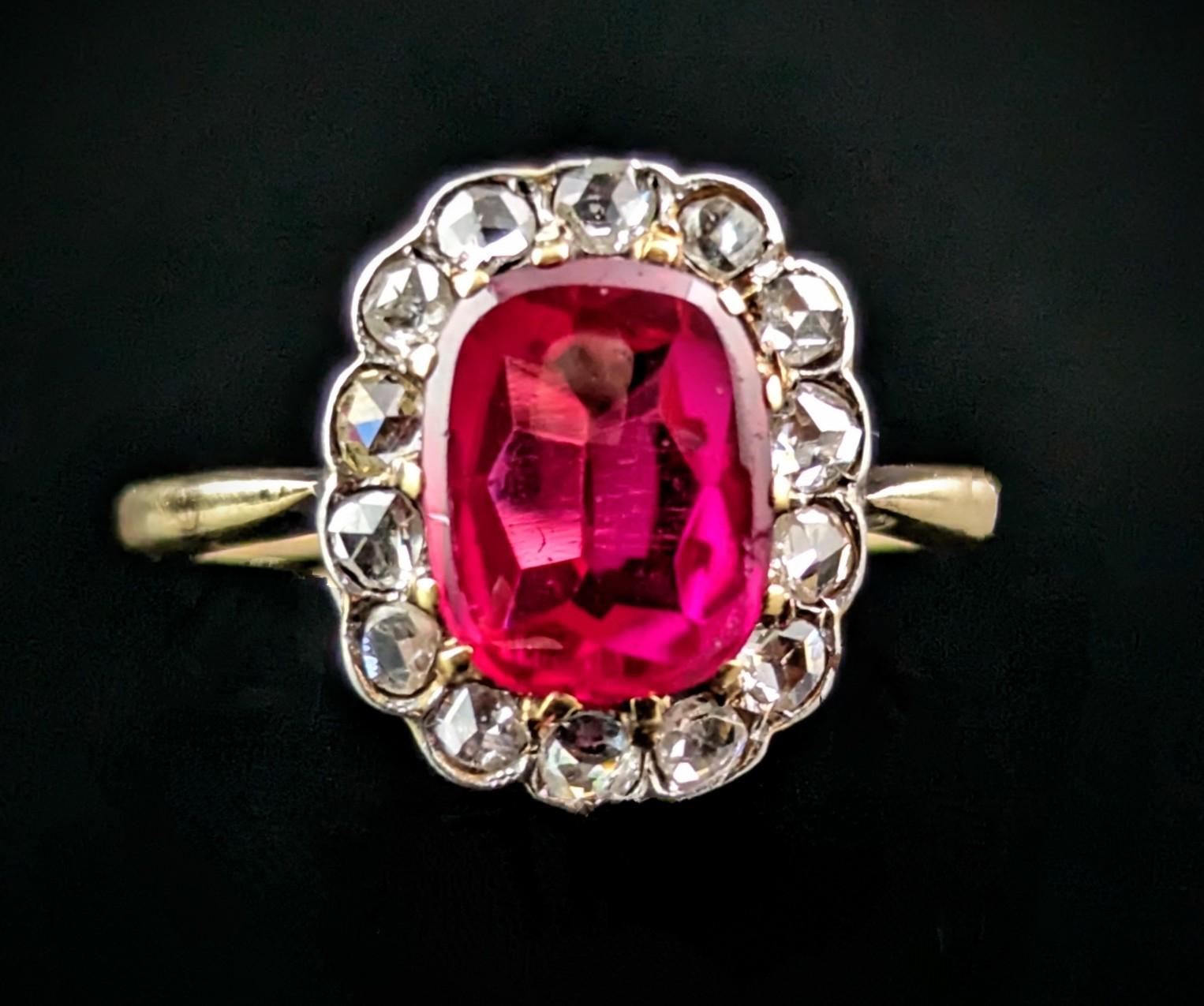 This Art Deco era Synthetic Ruby and Rose cut diamond cluster ring is a real beauty.

The ring features a vibrant cushion cut synthetic ruby, the ruby has a smooth polished table almost like a flat cabochon and this gives a lovely glossy shine, it