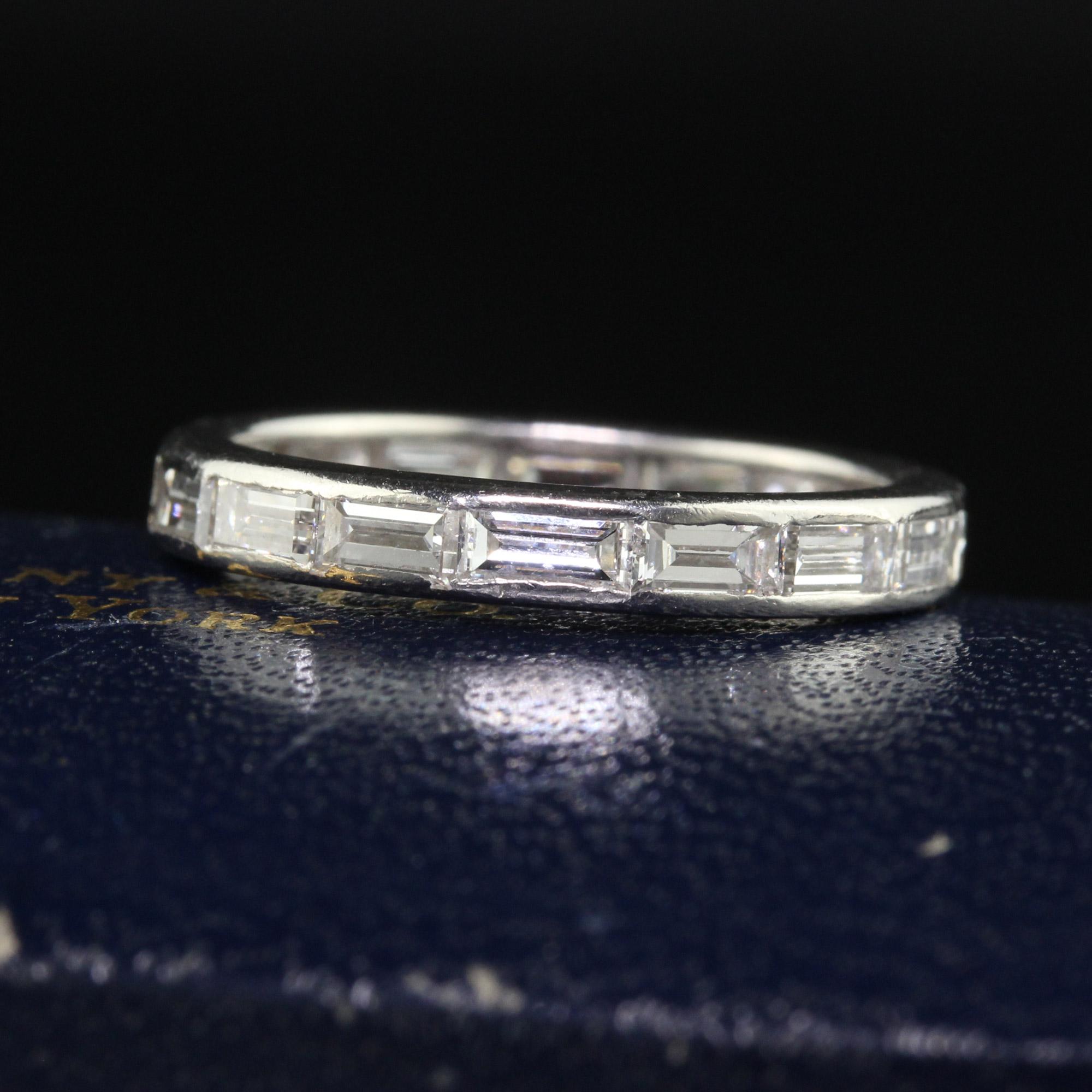 Beautiful Antique Art Deco Tiffany and Co Baguette Diamond Wedding Band - Size 6. This beautiful Tiffany and Co wedding band is crafted in platinum. The ring holds white and clean baguette diamonds that are set east to west around the entire ring.