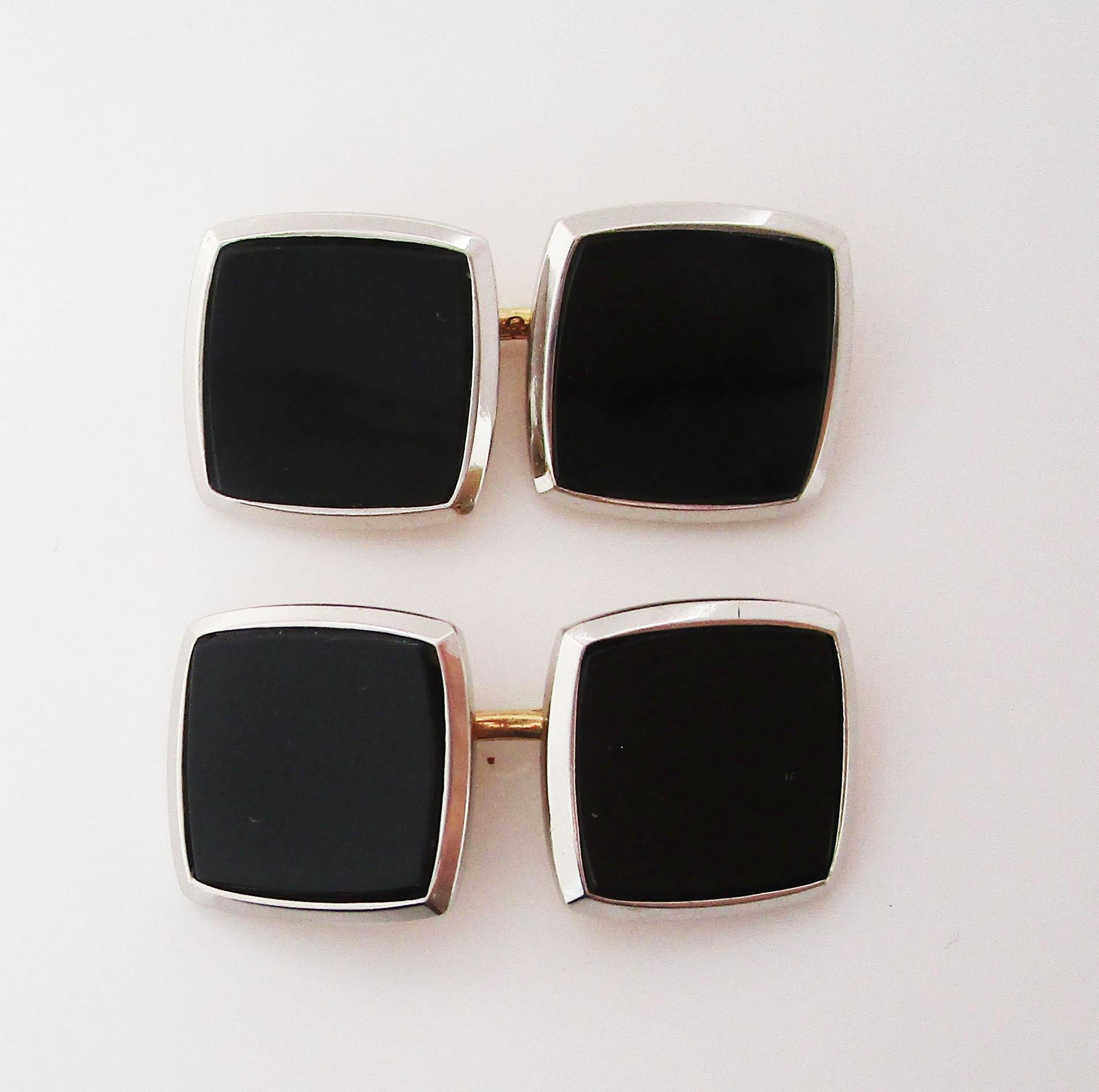 This elegant pair of cufflinks is original Art Deco links from 1920 in two colors of 14k gold with black onyx centers. The backs of the links are warm 14k yellow gold, while the frames of the panels are bright 14k white gold. The center of the