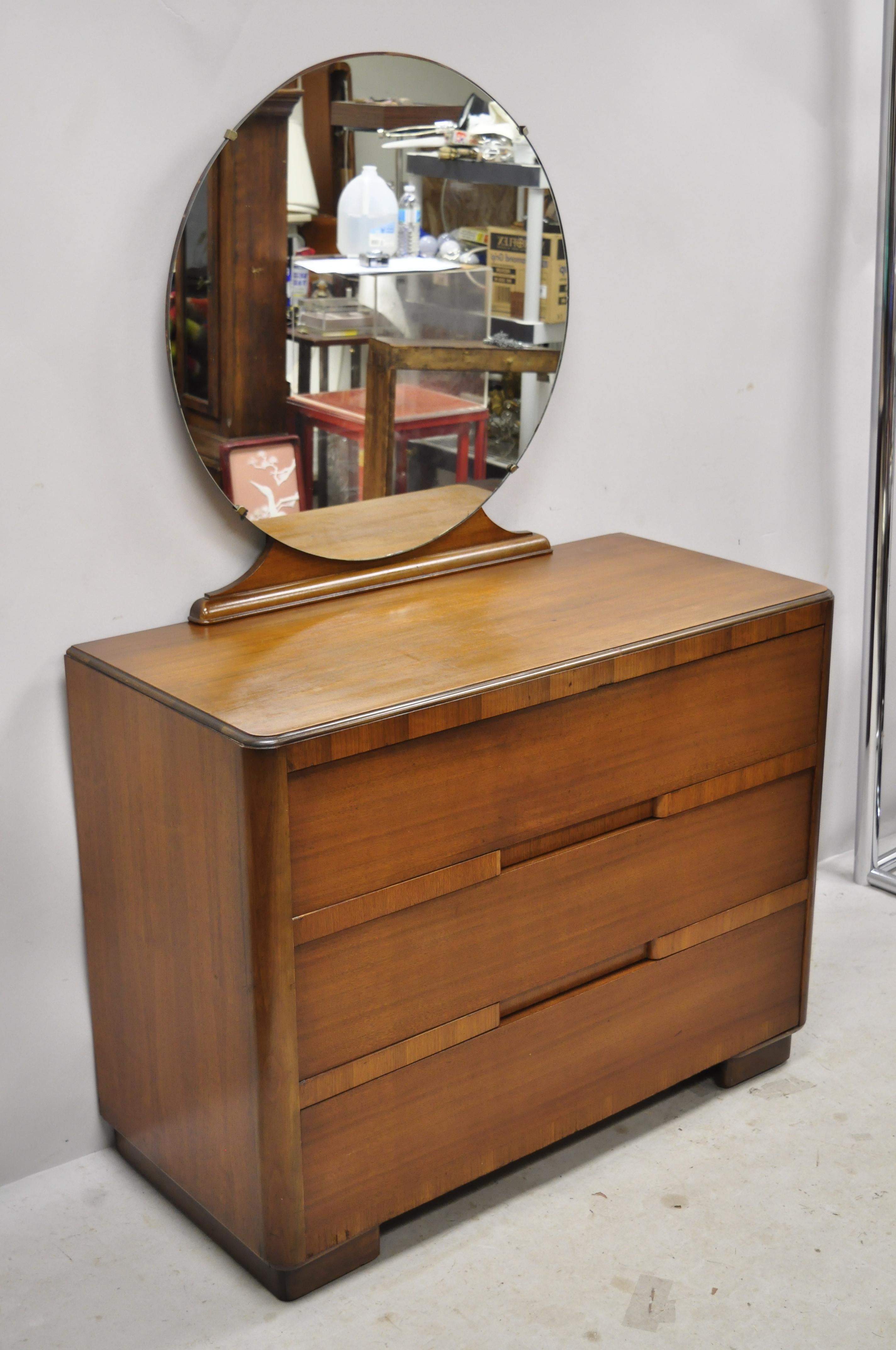 Antique Art Deco inlaid waterfall 3-drawer dresser chest with round mirror. Item features round plain glass mirror, beautiful wood grain, 3 dovetailed drawers, very nice vintage item, clean modernist lines, quality American craftsmanship, circa