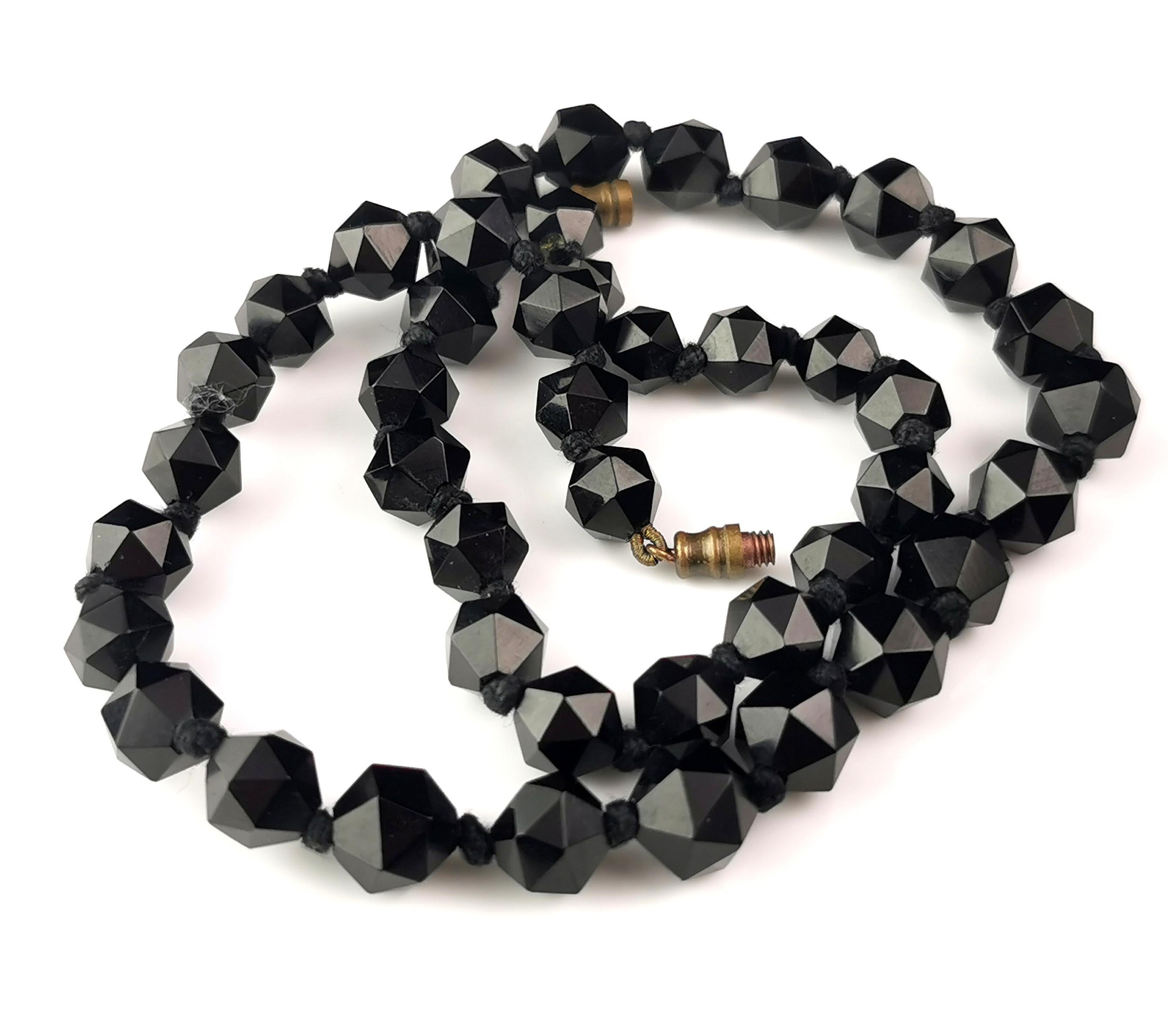 A beautiful antique very early 1920s Whitby Jet bead necklace.

It is made up from meticulously hand carved, faceted jet beads, polished to a very high shine which gives a wonderful shine and shimmer on movement.

Craftsmen were incredibly skilled