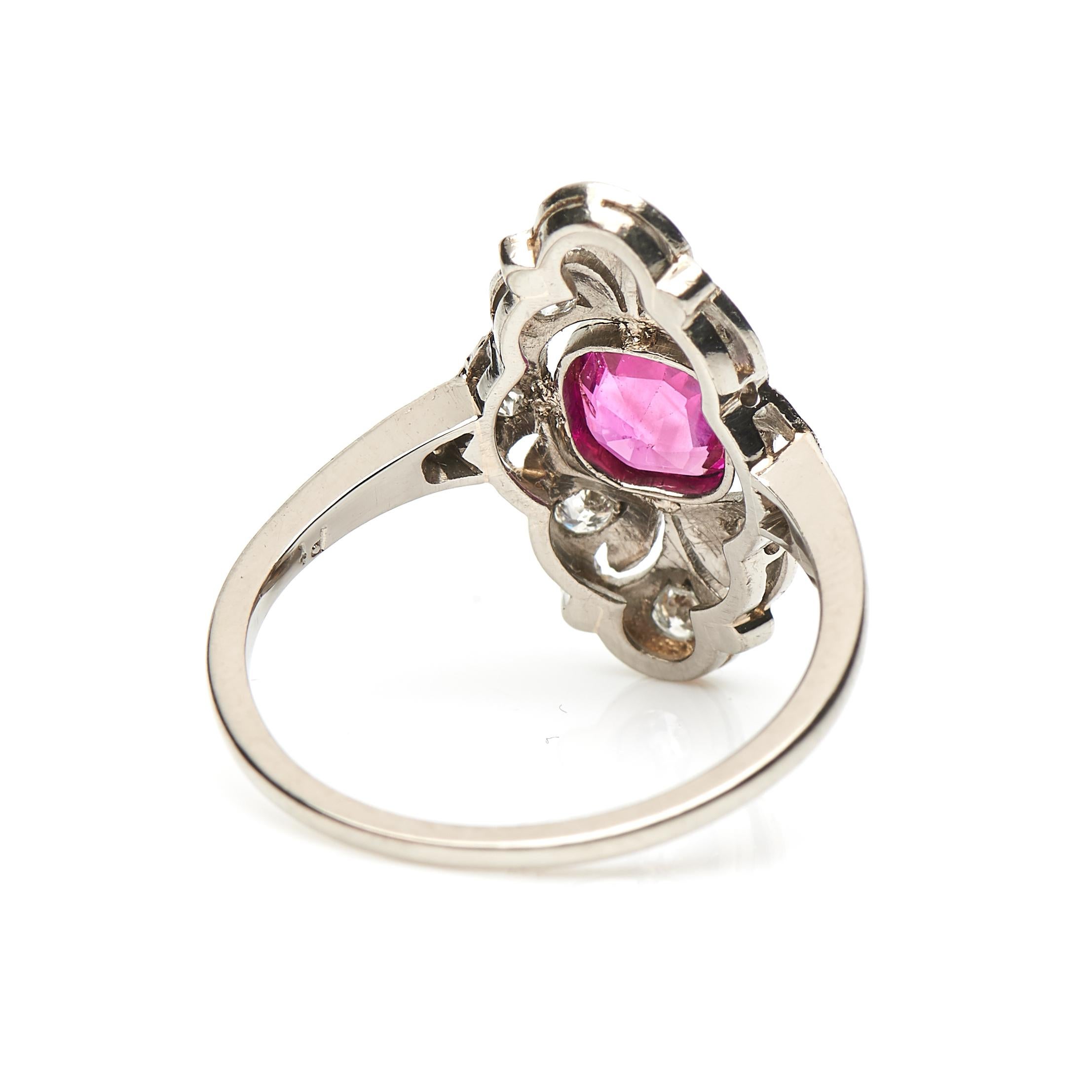 Early Art Deco, ruby and diamond plaque ring, circa 1920. Antique cushion-cut ruby set in an open-back millegrain and rubover setting surrounded by old cut diamonds in a beautifully carved open-worked setting with two further old-cut diamonds set in
