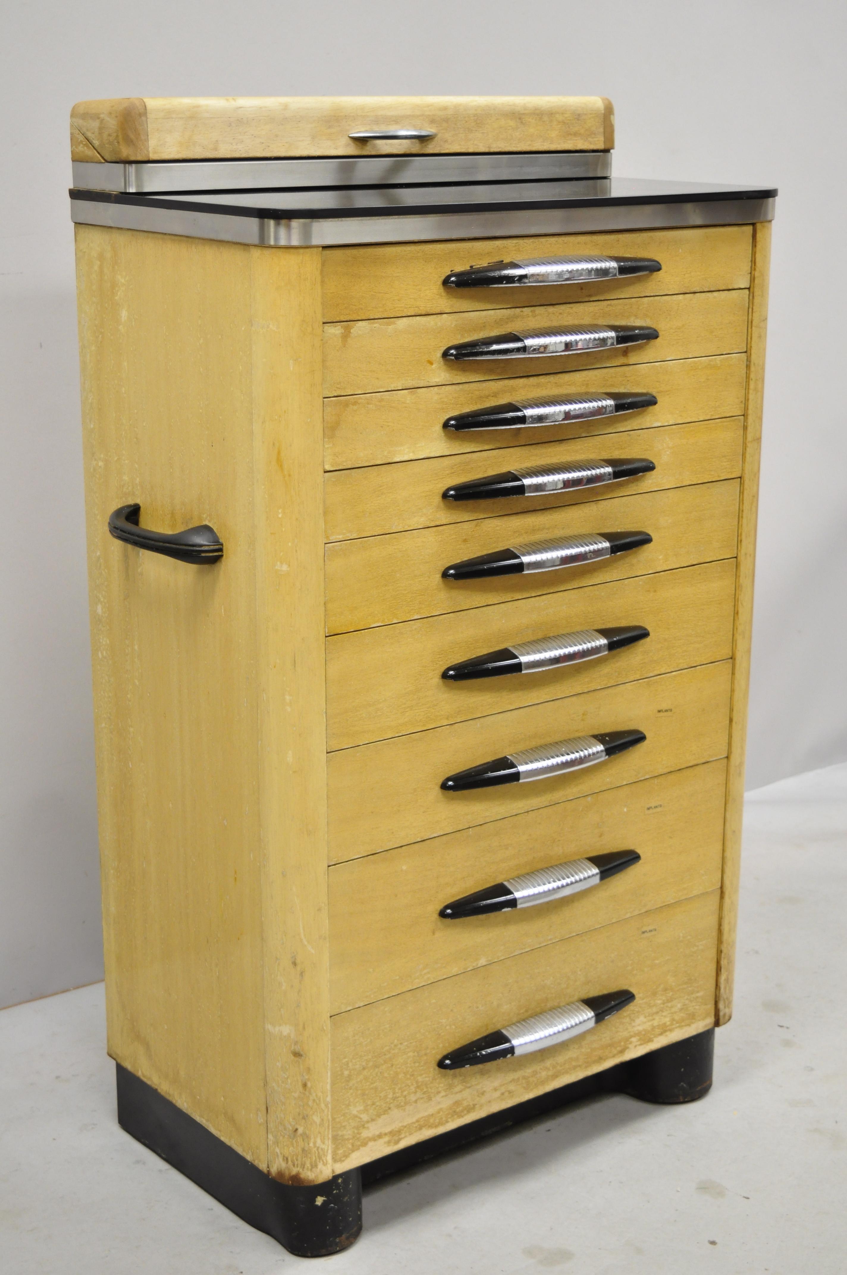 Antique Art Deco wood and metal medical dental Dentist Doctor's cabinet. Item includes Art Deco handles, laminate surface, lift top, handles to sides, circa early 20th century. Measurements: 43.5