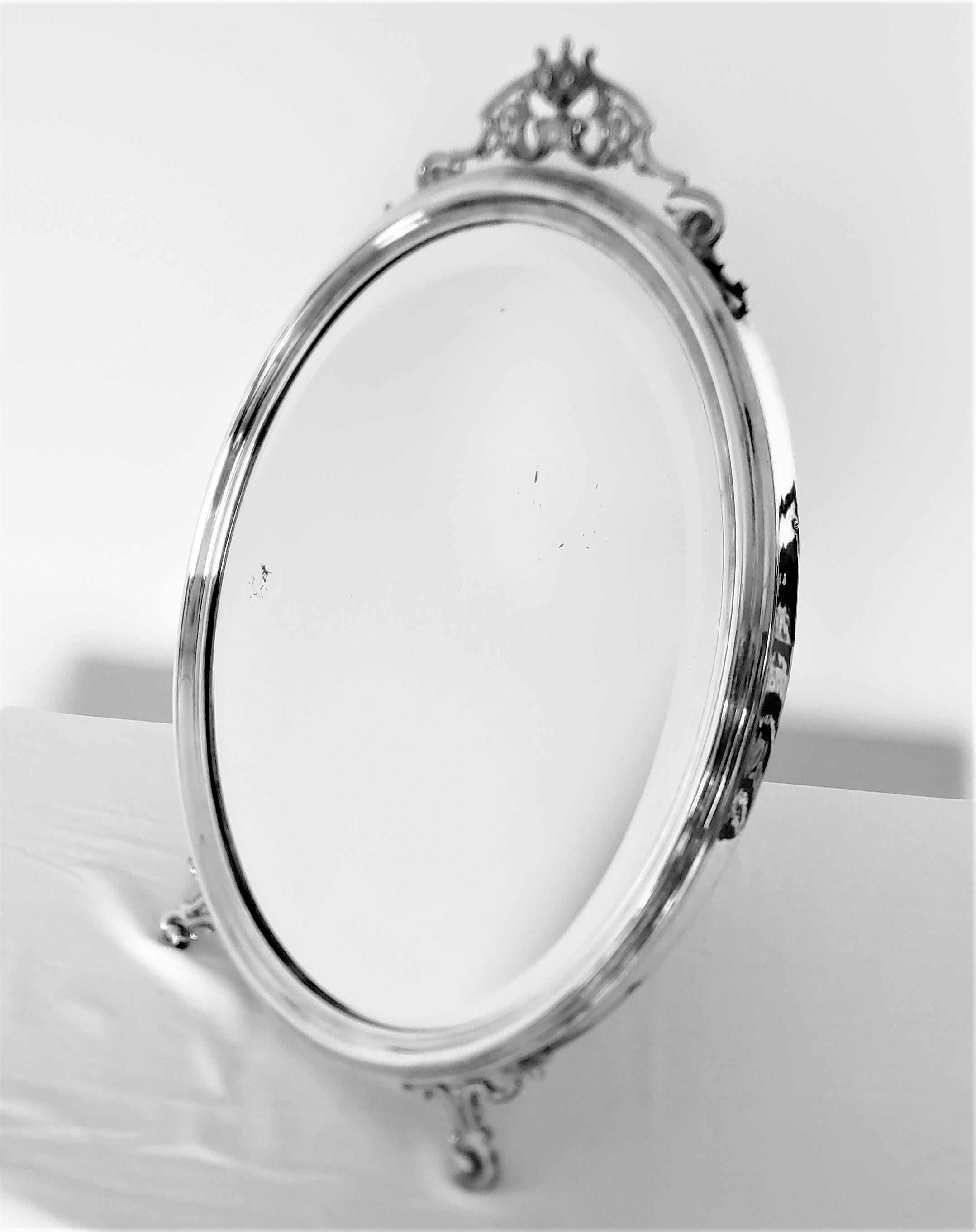 This antique silver plated oval mirror was made by the renowned Art Krupp Berndorf of England and dating to approximately 1900 and done in a period Edwardian style. This vanity or table mirror is very well constructed using a solid pine inner frame,
