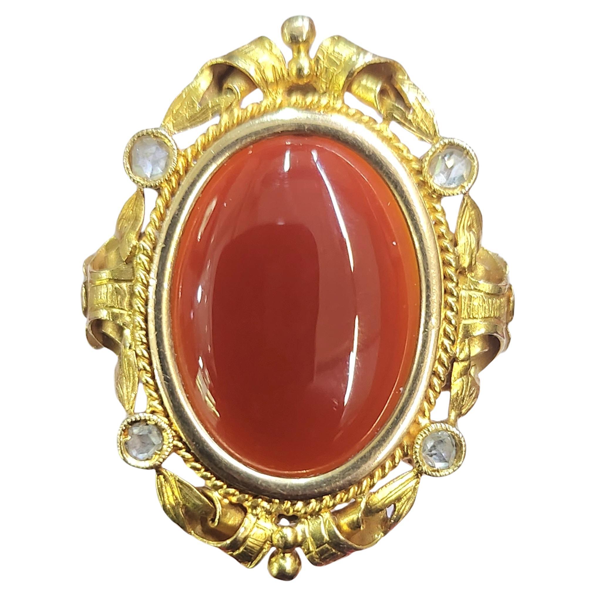 Antique art novouea 1900s 18k yellow gold ring in fine detailed workmanship centered with natural carnelian stone flanked with 4 rose cut diamonds in excellent condition