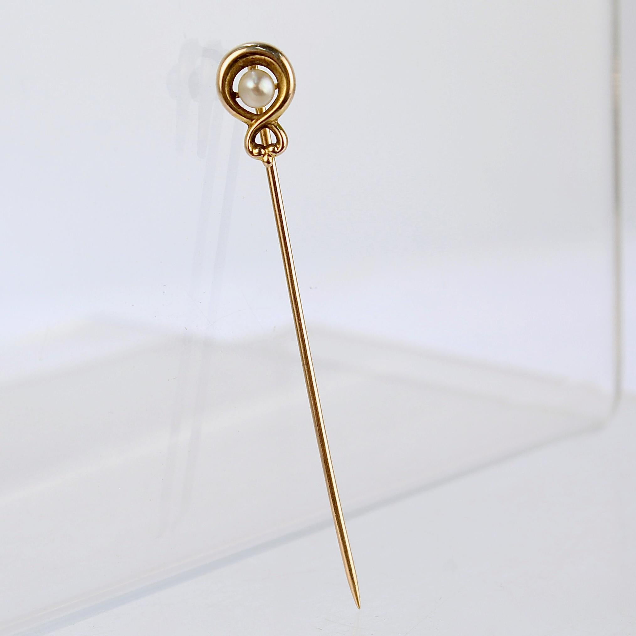 A very fine 10k gold and seed pearl stickpin.

With a round white pearl set in center of a 10k gold infinity loop.

Simply a great stickpin! 

Date:
Early 20th Century

Overall Condition:
It is in overall good, as-pictured, used estate