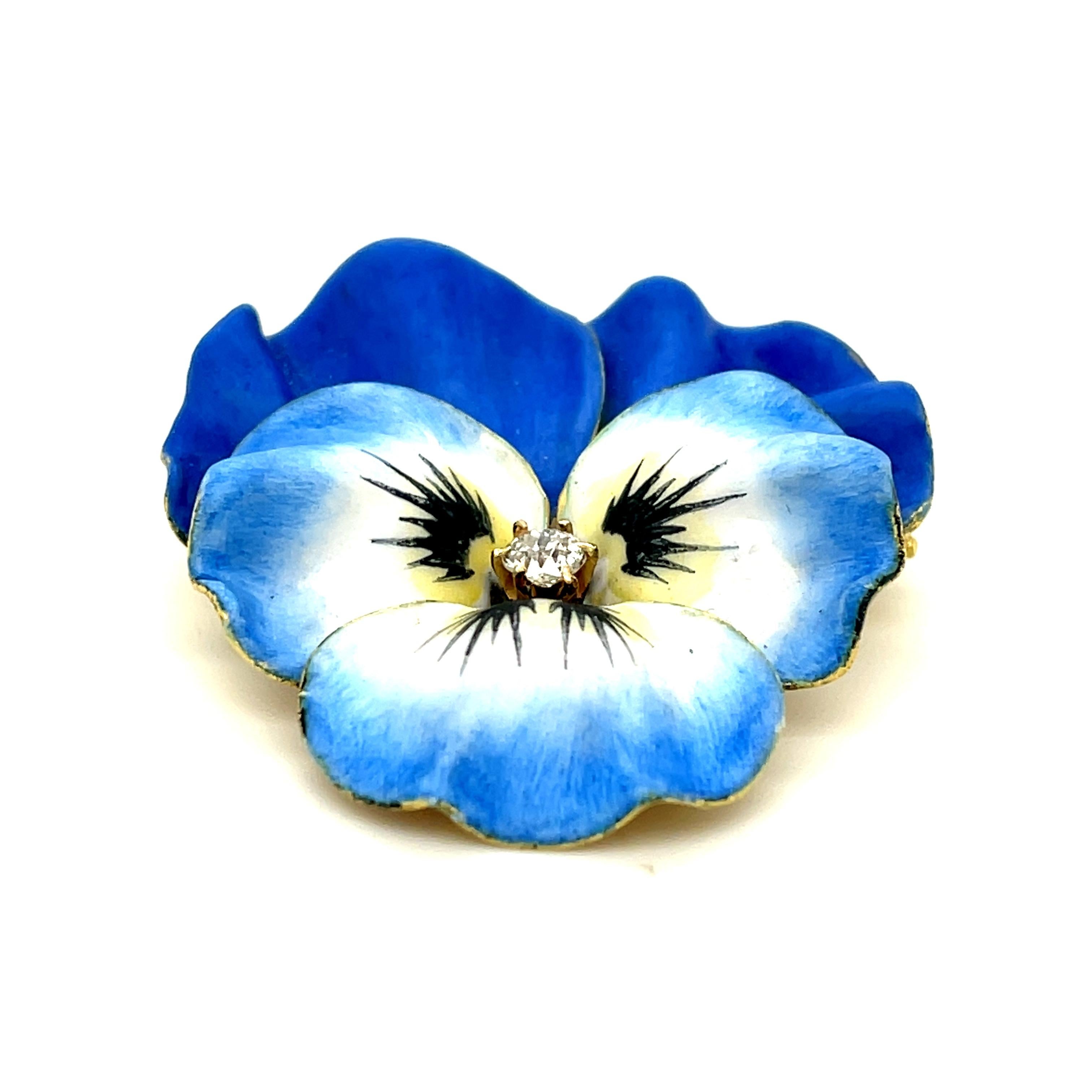 A beautiful blue enamel Art Nouveau pansy brooch set with a small diamond circa 1900. Made in 14k yellow gold. This pansy is a beautiful rendering of a flower that can be worn as a pin or a pendant. These sentimental pins were given as gifts to