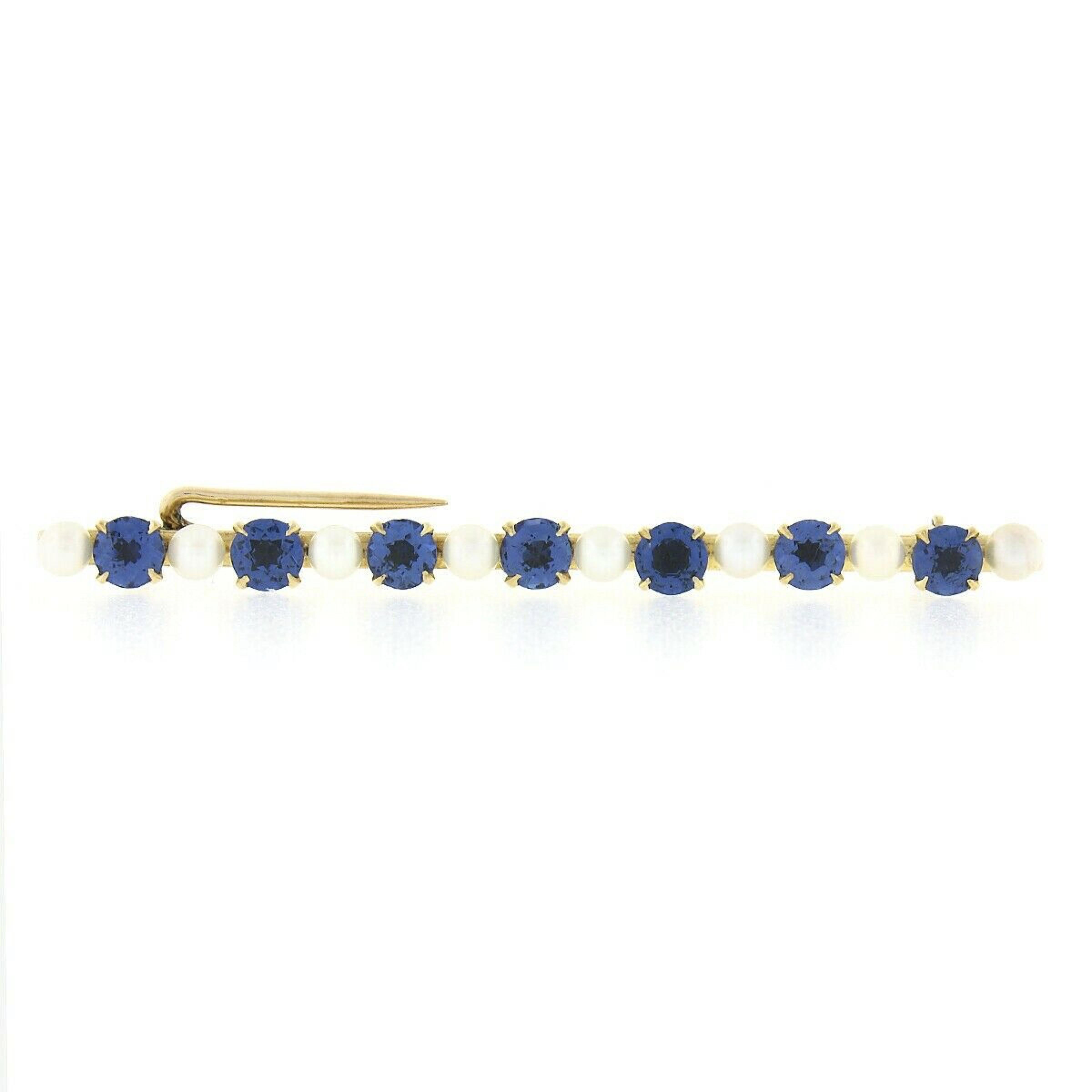 This magnificent antique bar pin brooch was crafted from solid 14k yellow gold during the art nouveau period and features 7, 100% natural, old round cut Montana sapphires of which two were randomly selected for certification by GIA. The sapphires