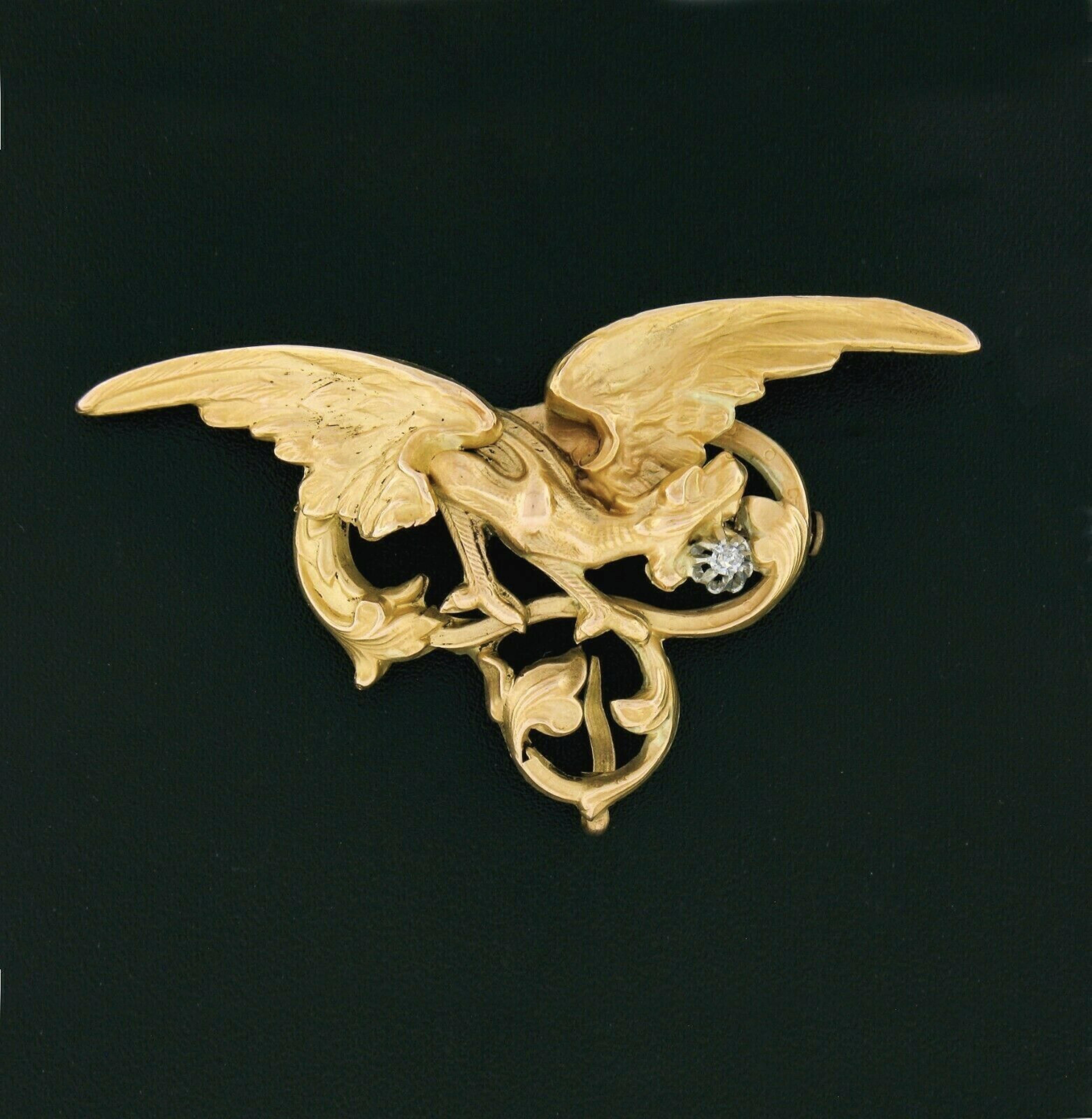 Here we have an outstanding antique brooch that was crafted during the art nouveau era from solid 14k yellow gold. The brooch features a large and very detailed 3D dragon design with a fine quality diamond neatly set at the center of a solid 14k