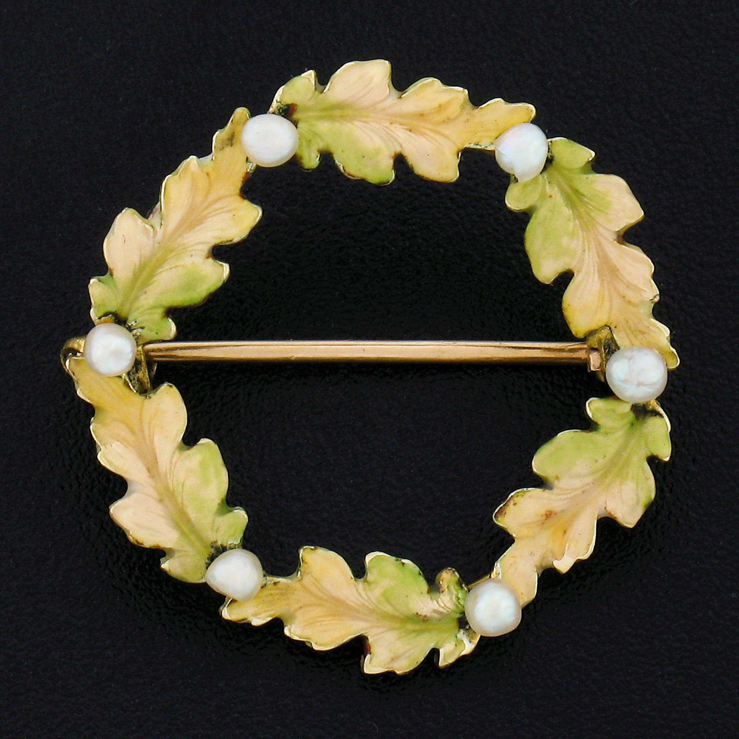 This beautiful antique brooch/pin was crafted during the art nouveau era in solid 14k yellow gold and features a lovely leaf circle wreath design. The wreath is adorned with beautiful leaves that are covered with matte finish light yellow and green
