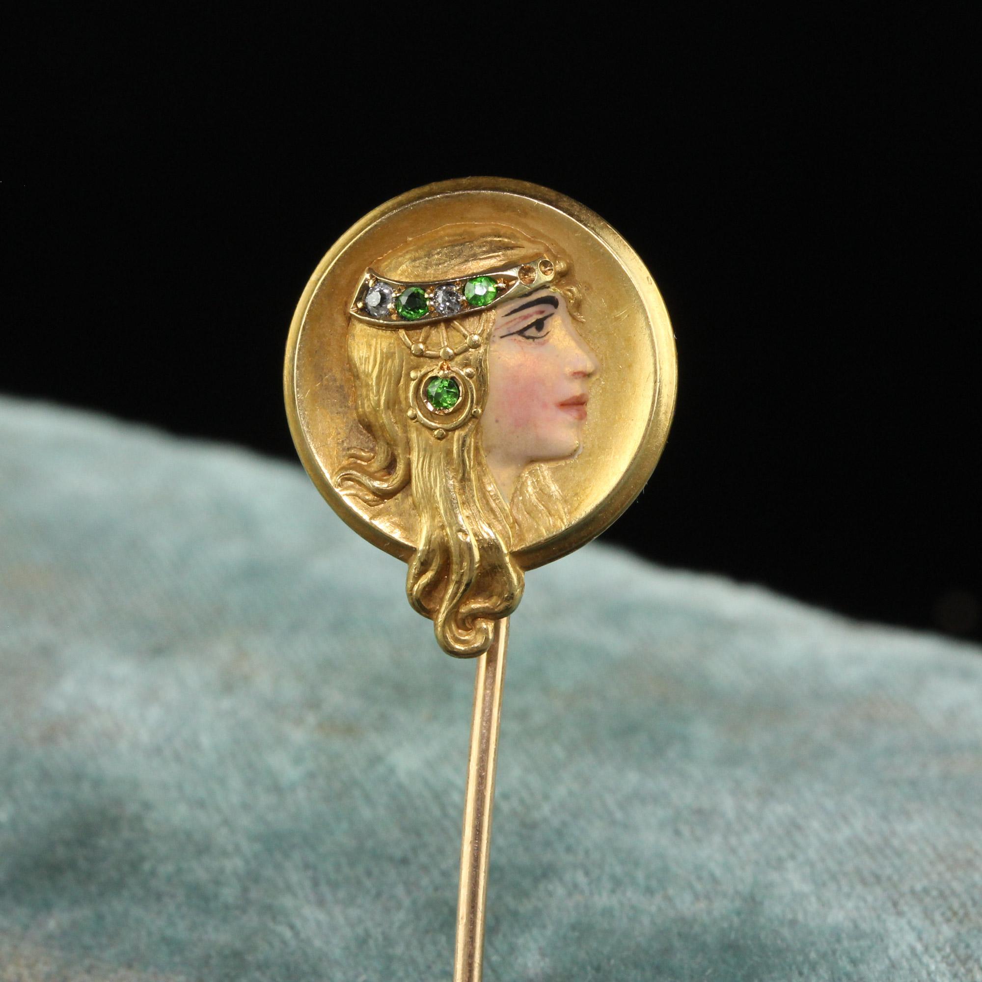 Beautiful Antique Art Nouveau 14K Yellow Gold Diamond Demantoid Enamel Lady Stick Pin. This gorgeous Art Nouveau stick pin is crafted in 14k yellow gold. The pin features a lady that has gorgeous enameling which resembles her makeup. She has a