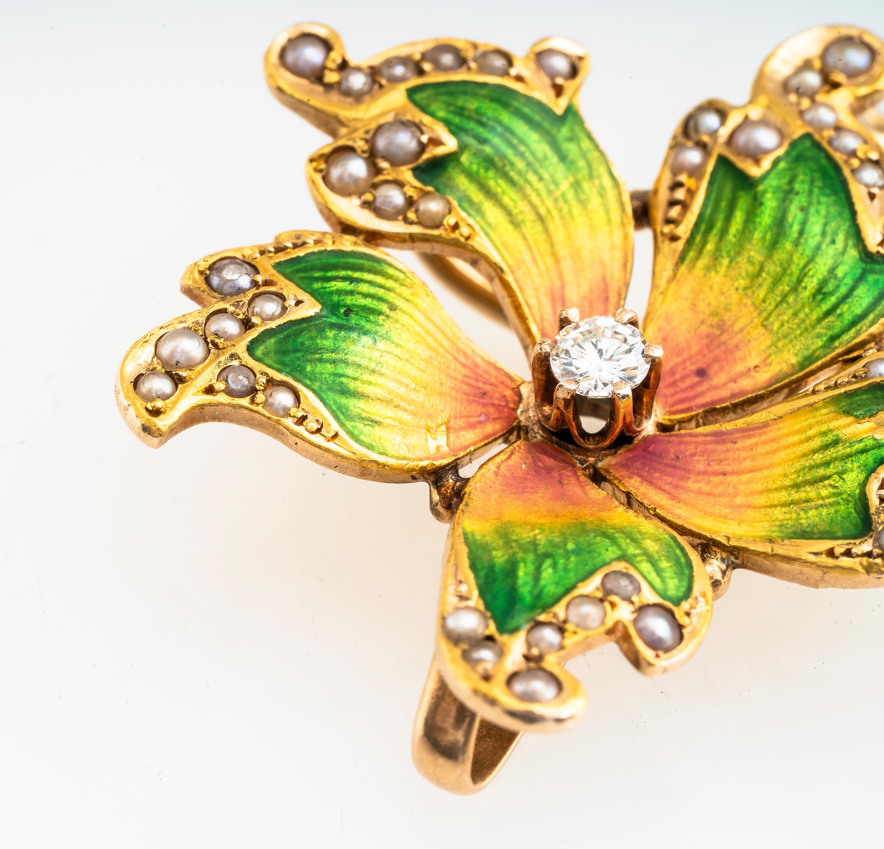 Antique Art Nouveau 14k yellow gold diamond and seed pearl enamel flower pendant/brooch.  Approximately 0.10 carat old European cut diamond J color and I1 clarity.   Enamel color transitions from green to yellow and then pink.   Can we worn as a