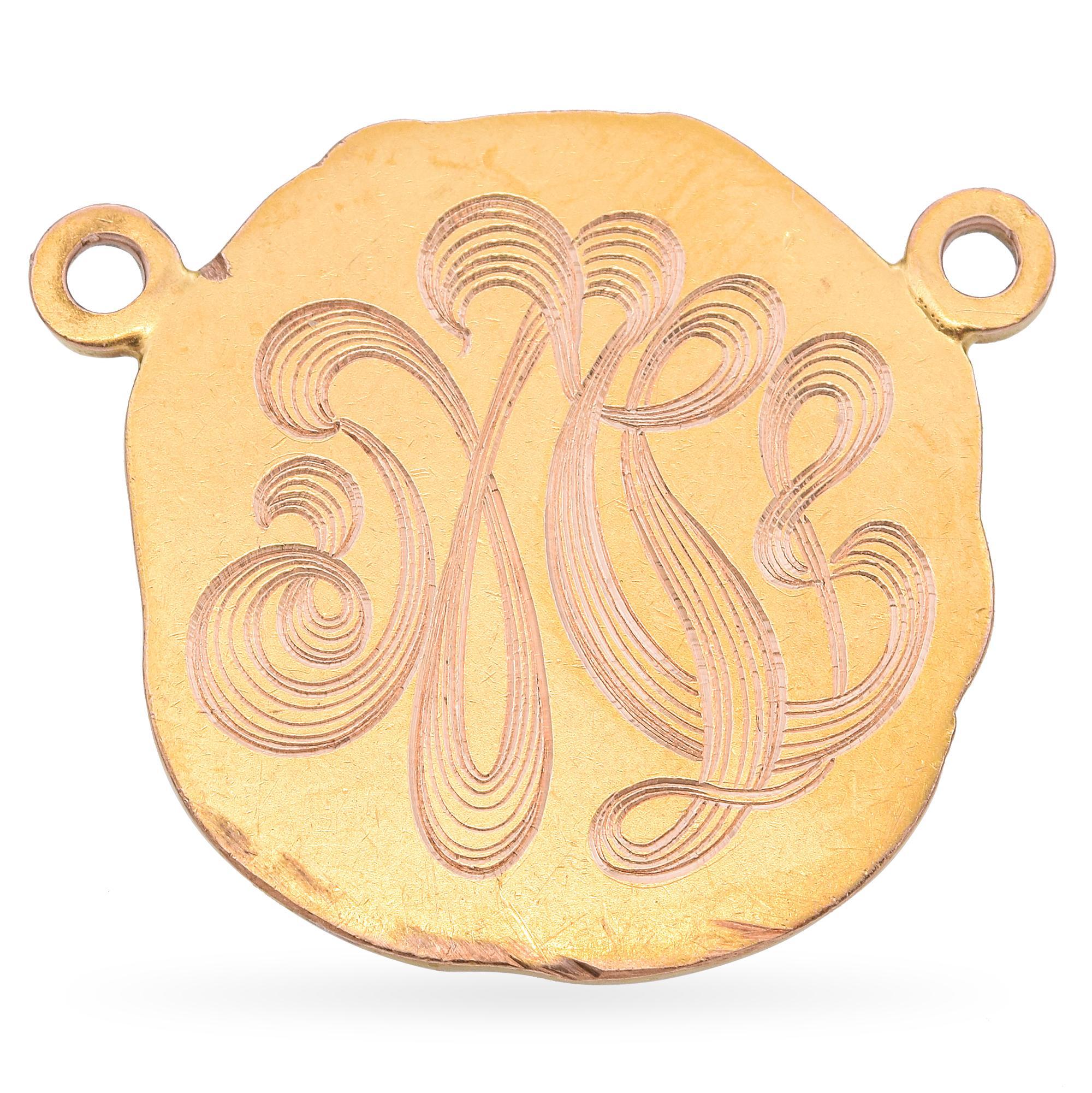 This exquisite pendant is crafted in the Art Nouveau style. The design features a detailed relief of a woman's profile surrounded by intricate floral and foliate motifs. The piece is rendered in a warm, golden hue, highlighting the delicate curves