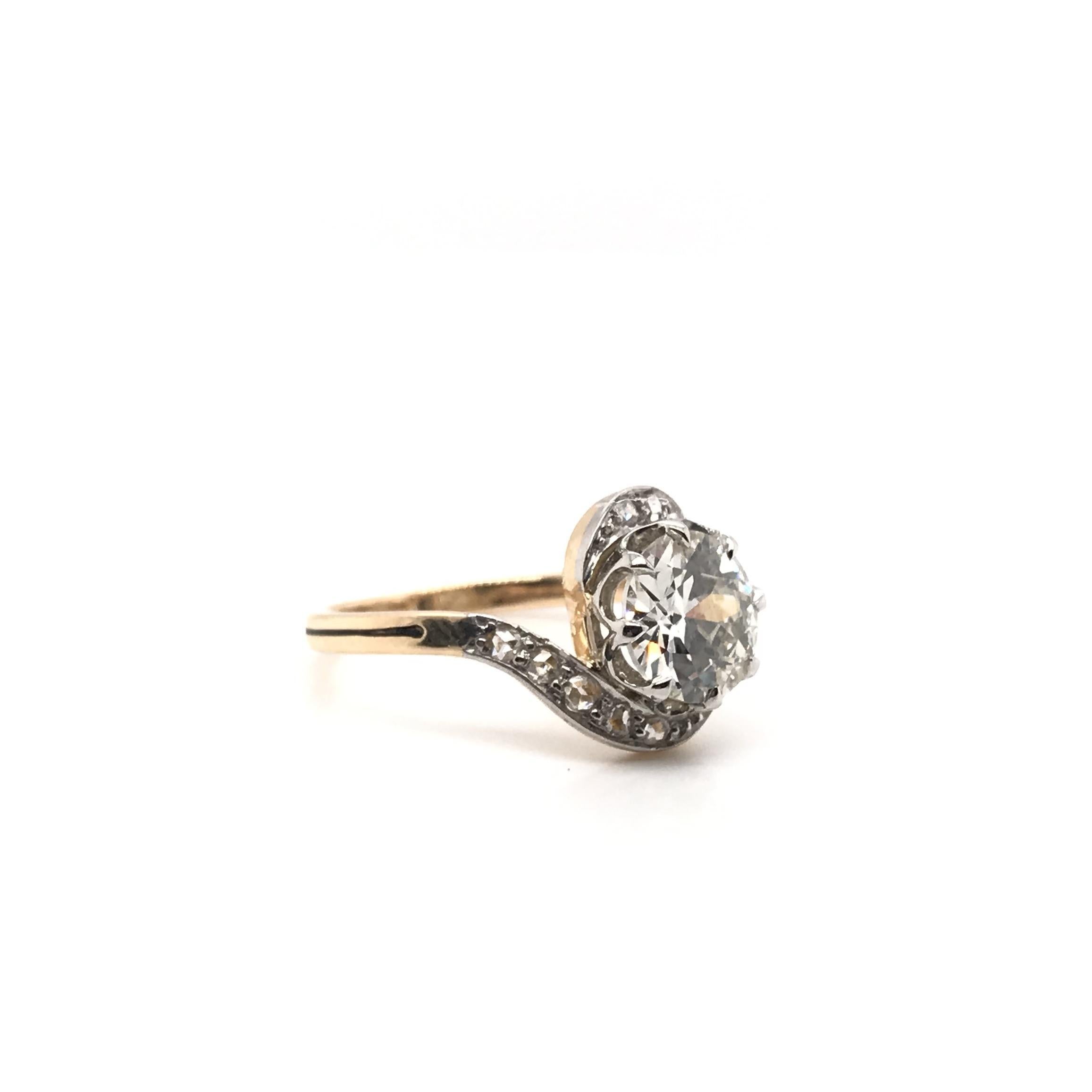 This antique piece was crafted sometime during the Art Nouveau design period (1890-1910). The center diamond is an antique Old European cut and has been certified by the Gemological Institute of America. The diamond grades approximately L in color