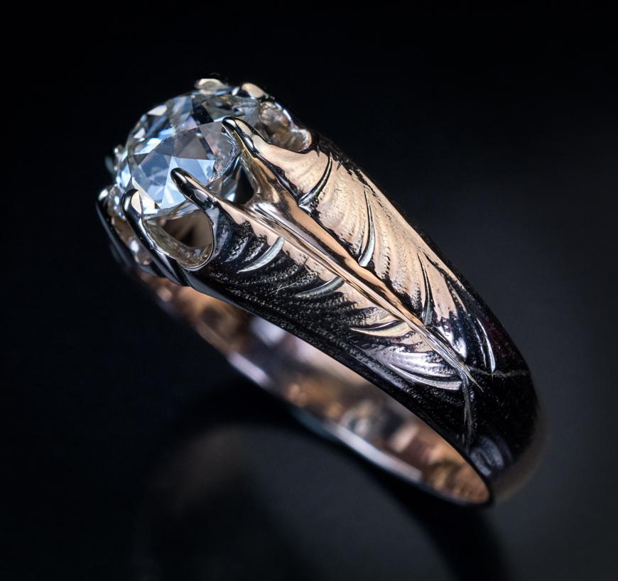 This Art Nouveau era antique Russian unisex 14K gold ring was made in Odessa between 1908 and 1907.

The ring features a sparkling 1.70 ct old cushion cut diamond (K color, VS2 clarity) flanked by Art Nouveau leaf designs.

The diamond measures 7.61