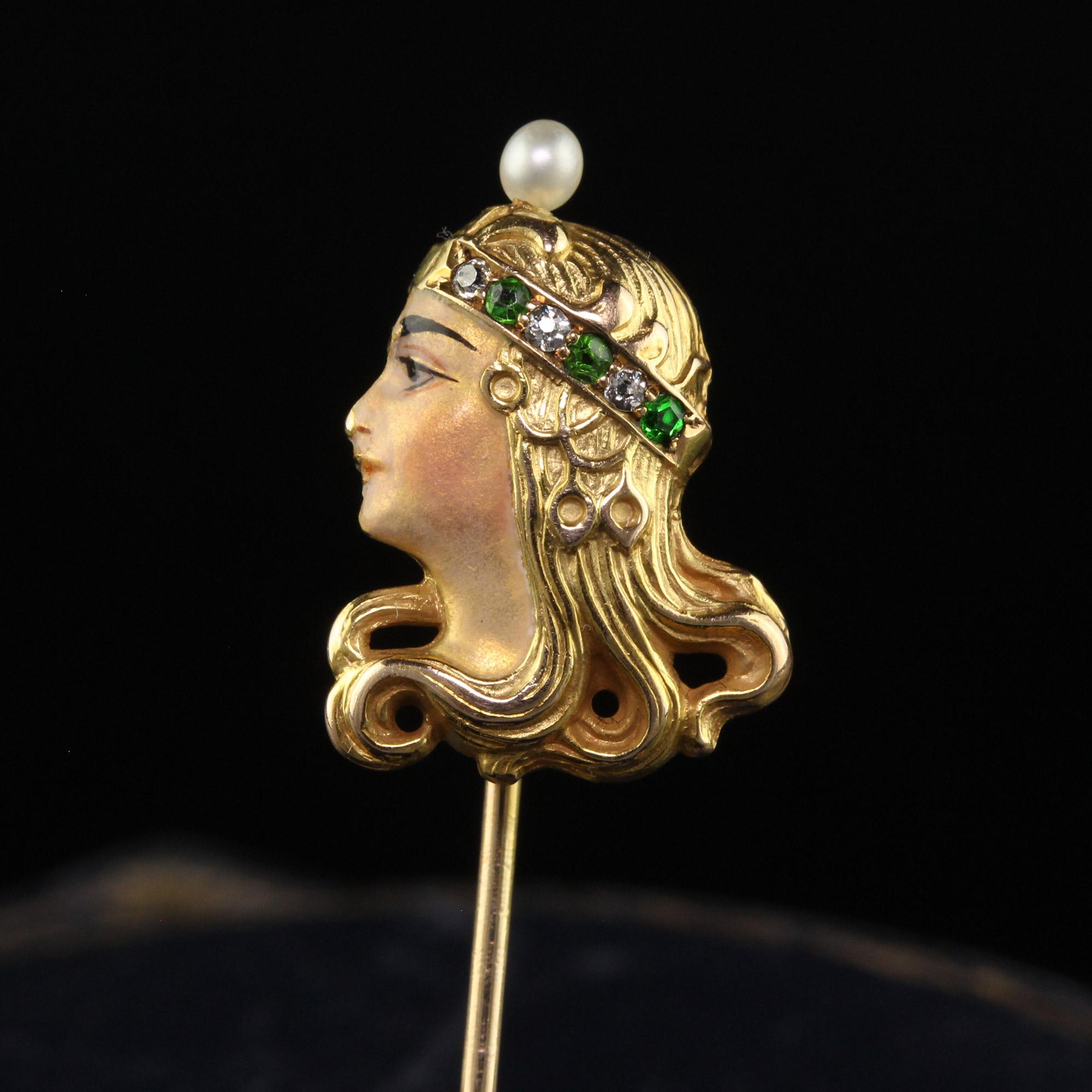 Beautiful Antique Art Nouveau 18K Yellow Gold Diamond Demantoid Pearl Lady Stick Pin. This incredible Art Nouveau stick pin is crafted in 18k yellow gold. The pin features a profile of a lady with a hand band that has diamonds and demantoid garnets