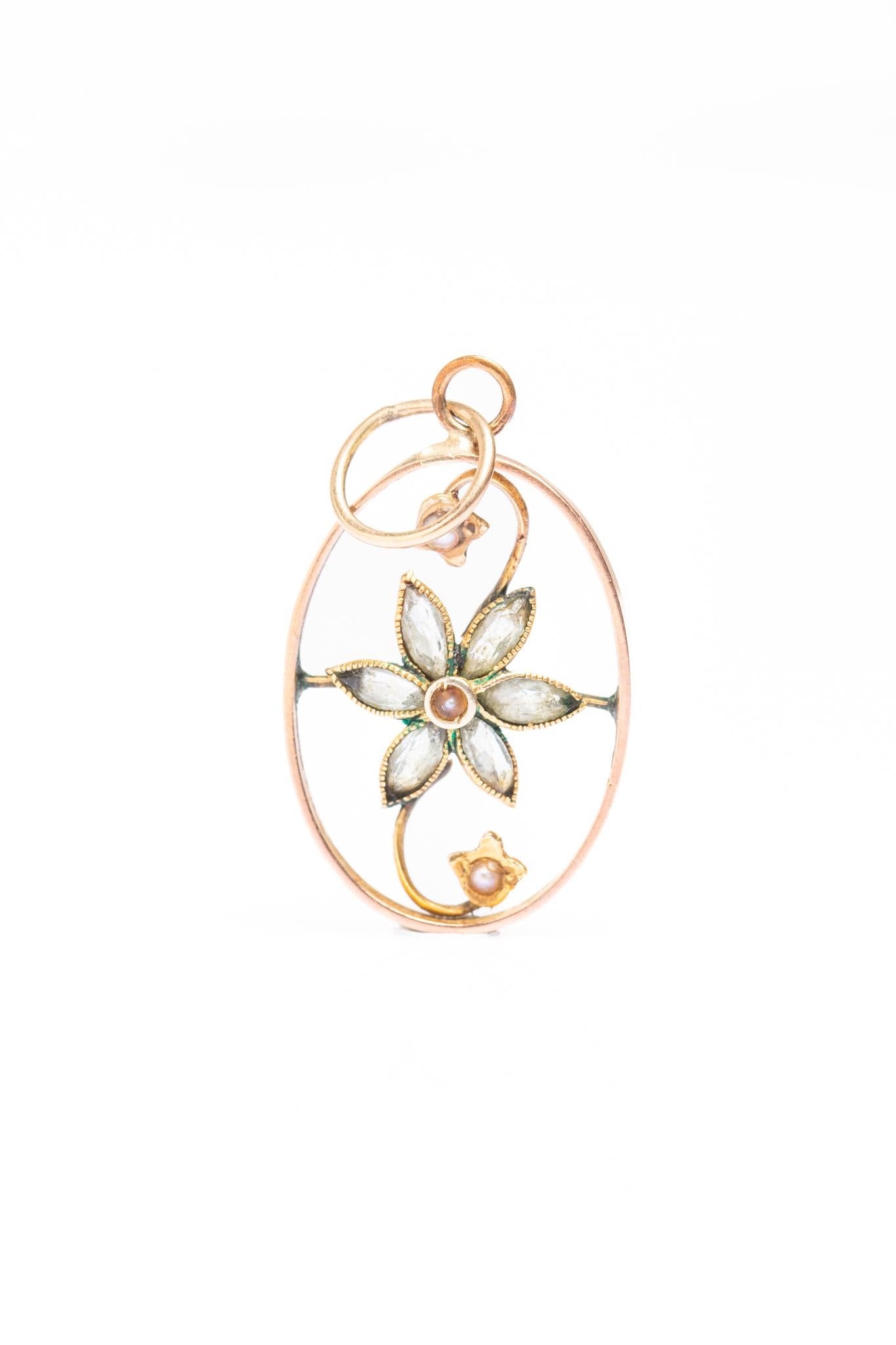 Charming Art Nouveau 9ct Gold floral pendant dated circa 1900's. This lovely open design features central floral panel decorated with semi precious stones and lustre pearls. It has a scrolled motif with two tiny flowers rising from the central