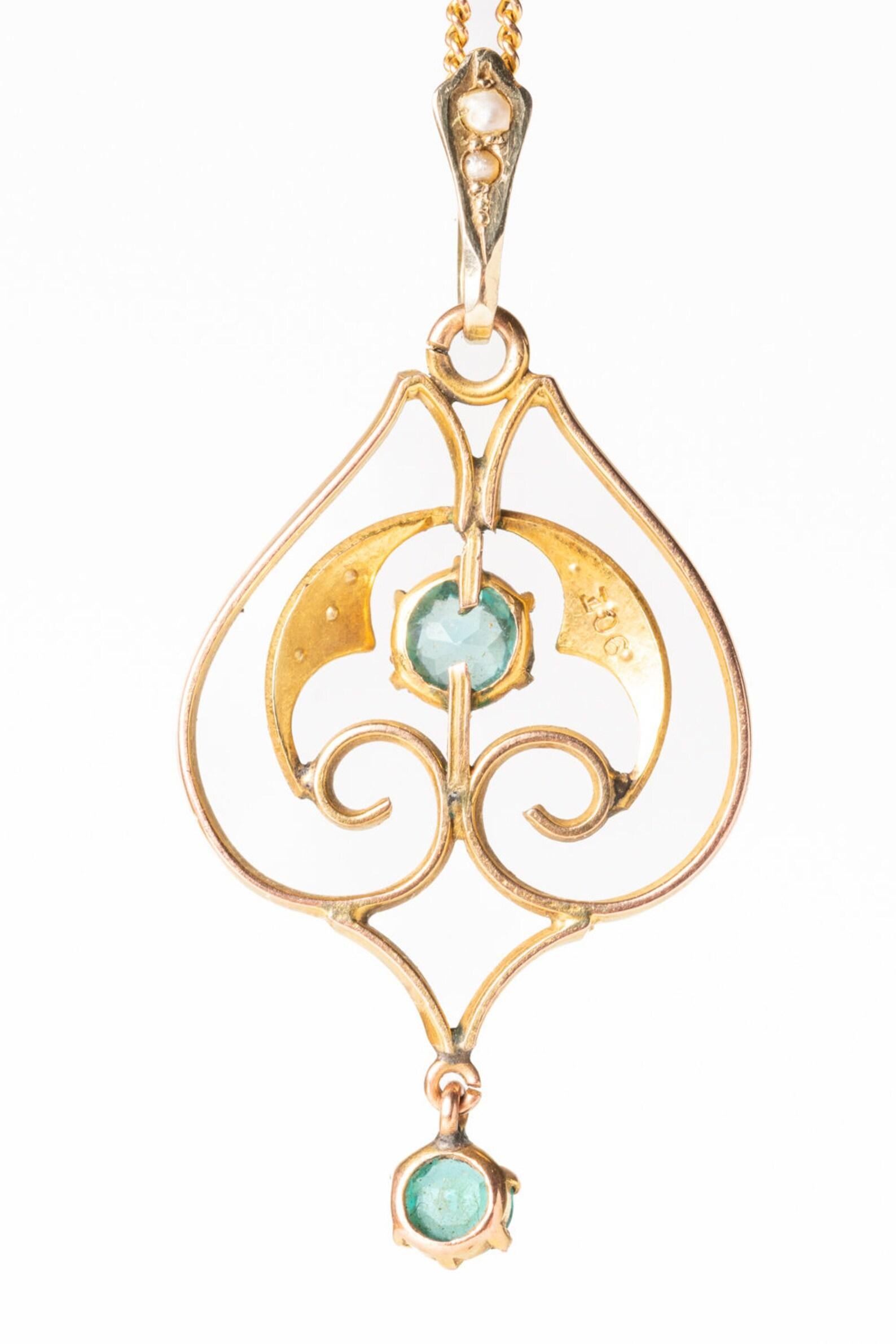 A beautiful Art Nouveau lavalier 9ct gold pendant decorated with two round topaz stones together with six lustre seed pearls. The pendant is designed in a typical for Art Nouveau style.

The Blue Topaz symbolizes a channel of your inner wisdom and