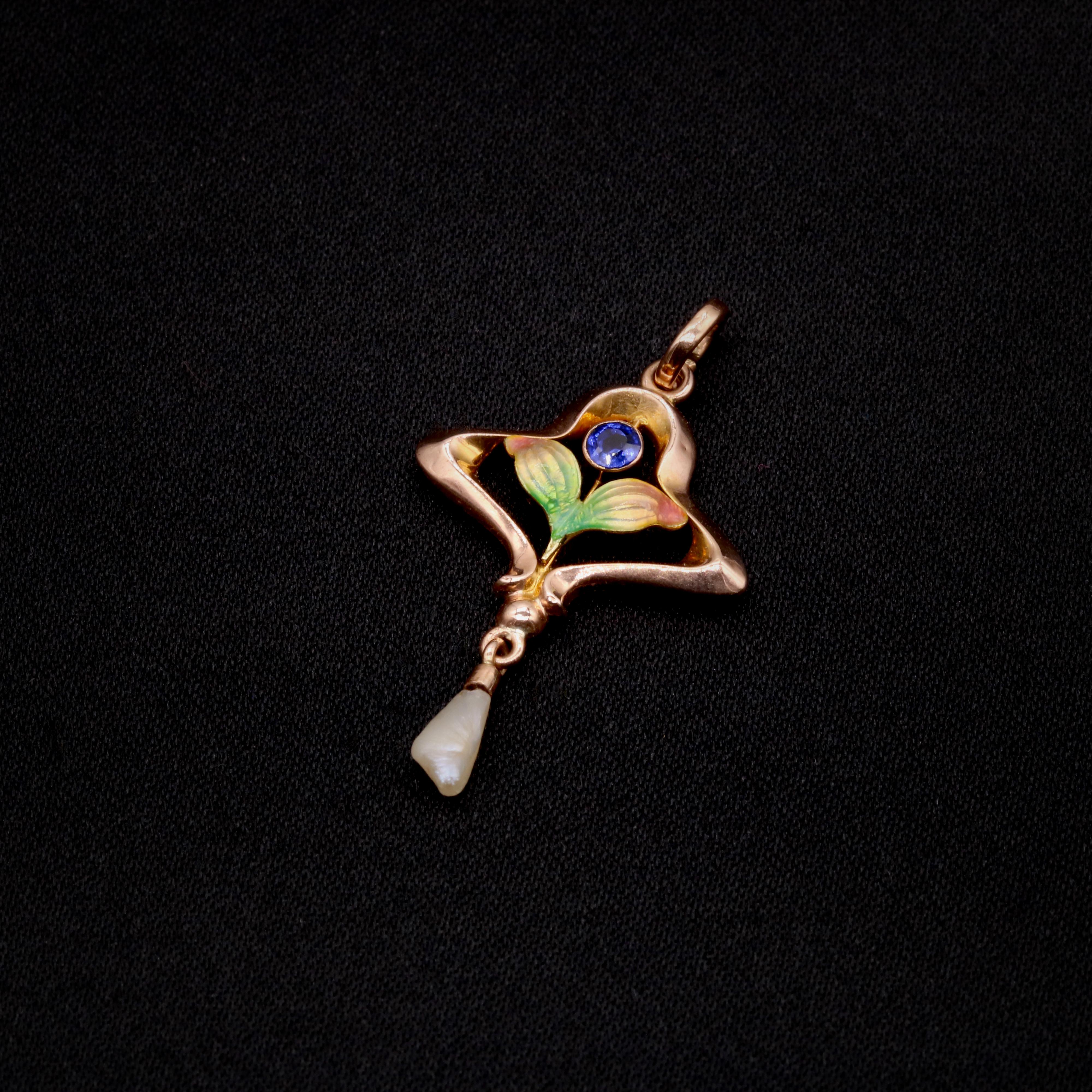 An Art Nouveau blue paste, pearl, enamel, and yellow gold pendant, comprising one round cut blue paste gem, one baroque pearl, and vari-colour enamel, in 9 karat yellow gold. 

My favourite thing about this Art Nouveau 9K Yellow Gold Blue Paste,