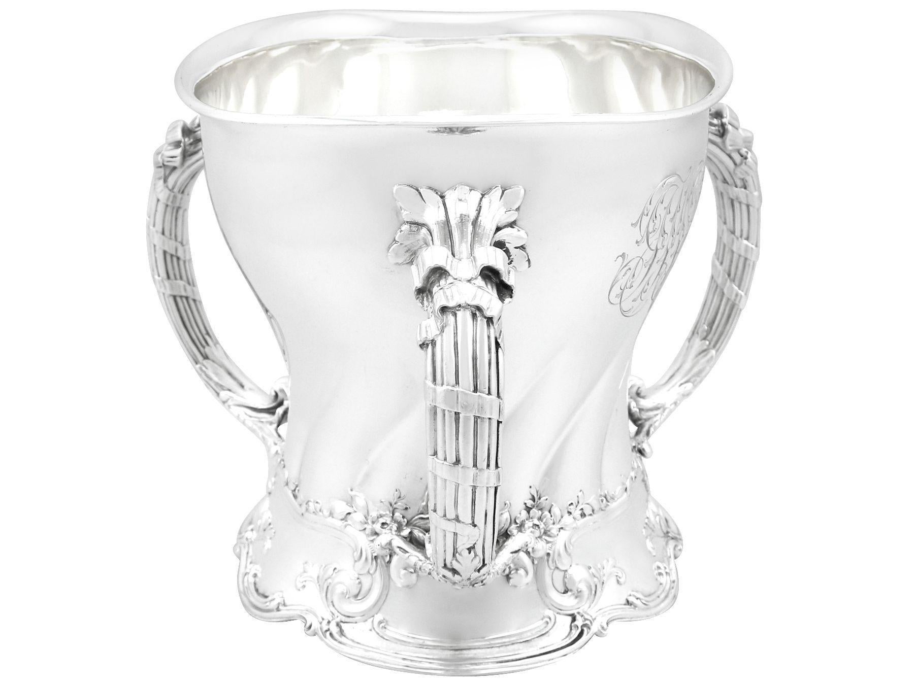 An exceptional, fine and impressive antique American sterling silver tyg presentation / champagne cup in the Art Nouveau style; an addition to our ornamental silverware collection.

This exceptional antique American sterling silver tyg