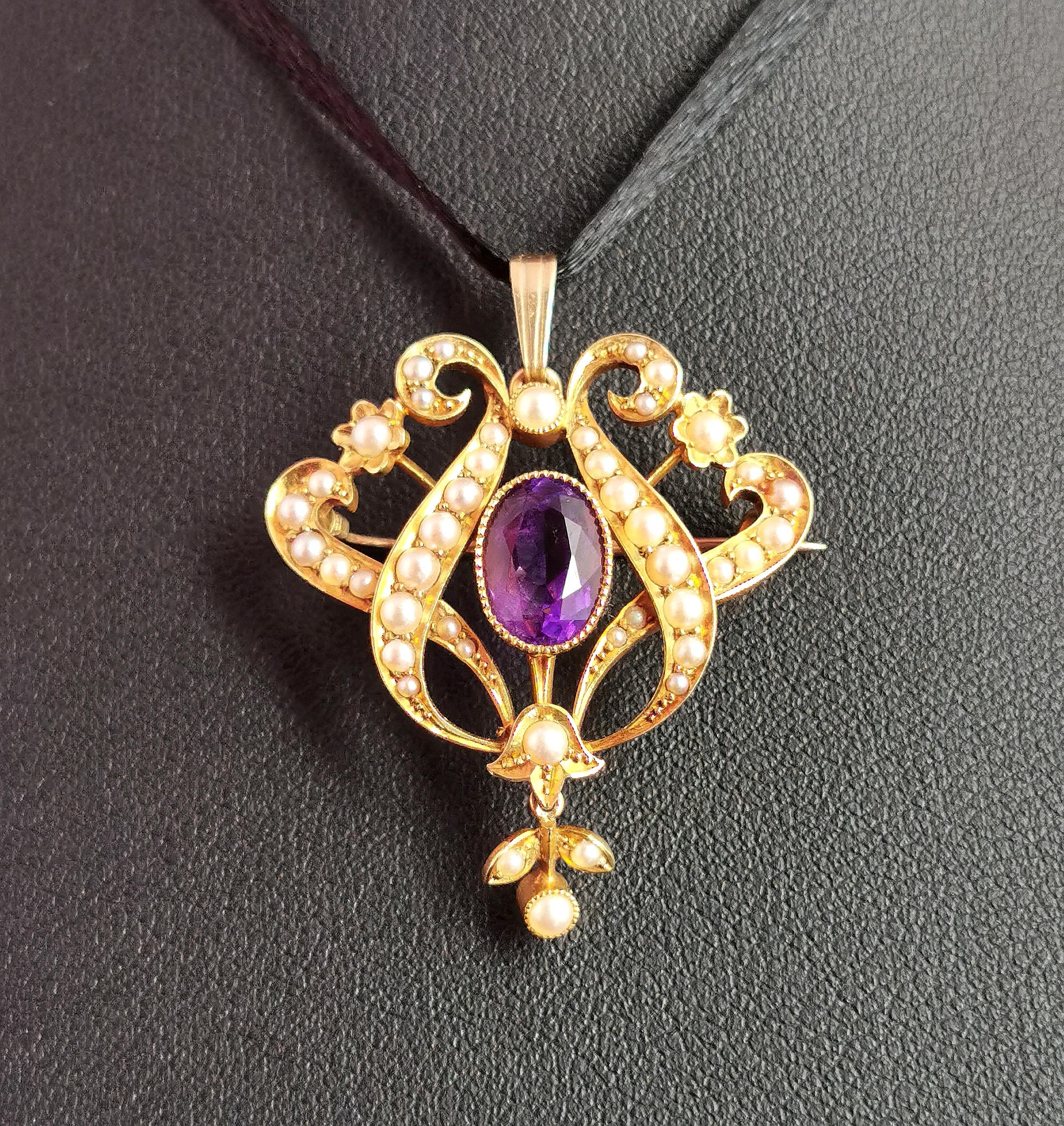 A truly stunning antique Art Nouveau era Amethyst and pearl pendant brooch in 15kt yellow gold.

It is a beautifully crafted pieced, very well made and has an elaborate openwork design in a lyre shape set with creamy seed pearls, to the centre there