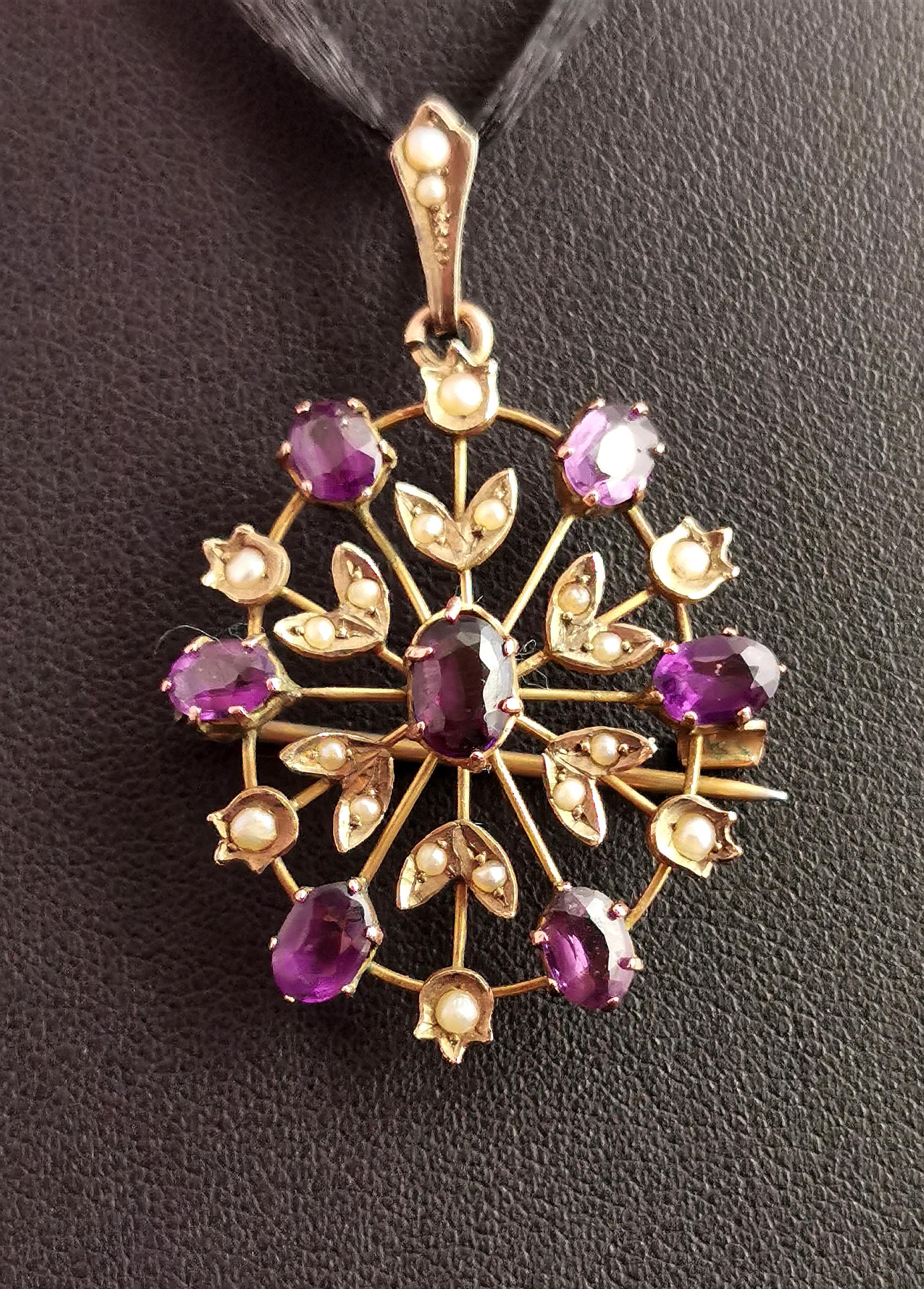A beautiful antique, Art Nouveau era brooch pendant.

This pretty and universal jewellery piece can be worn as either a pendant or a brooch.

It has an oval openwork design with tiny seed pearl set flowers set around the oval, the flower head and