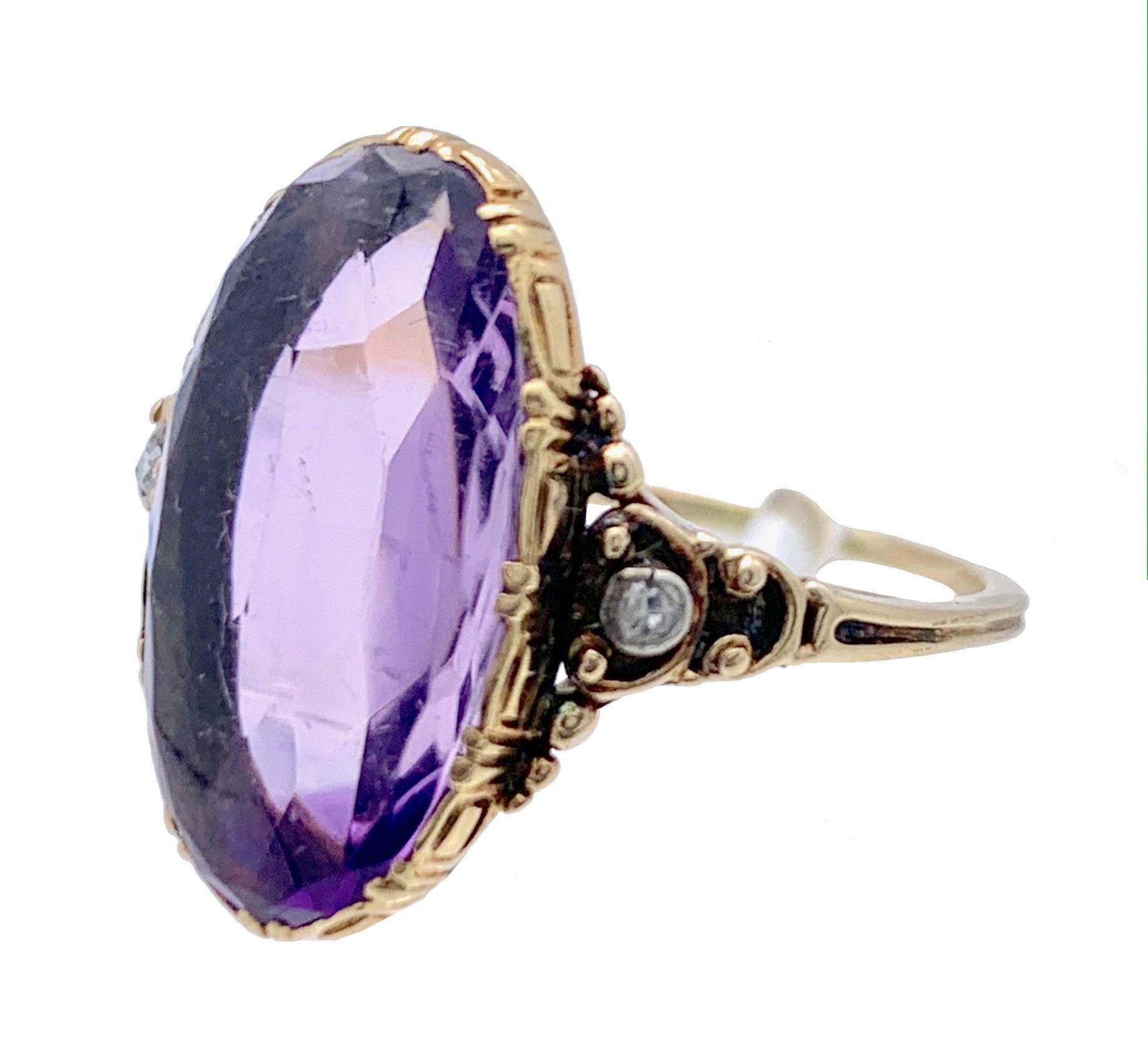 This oval amethyst cabochon is set in an elegant Art Nouveau ring. The ring shoulders are embellished with diamonds and granulation. 
