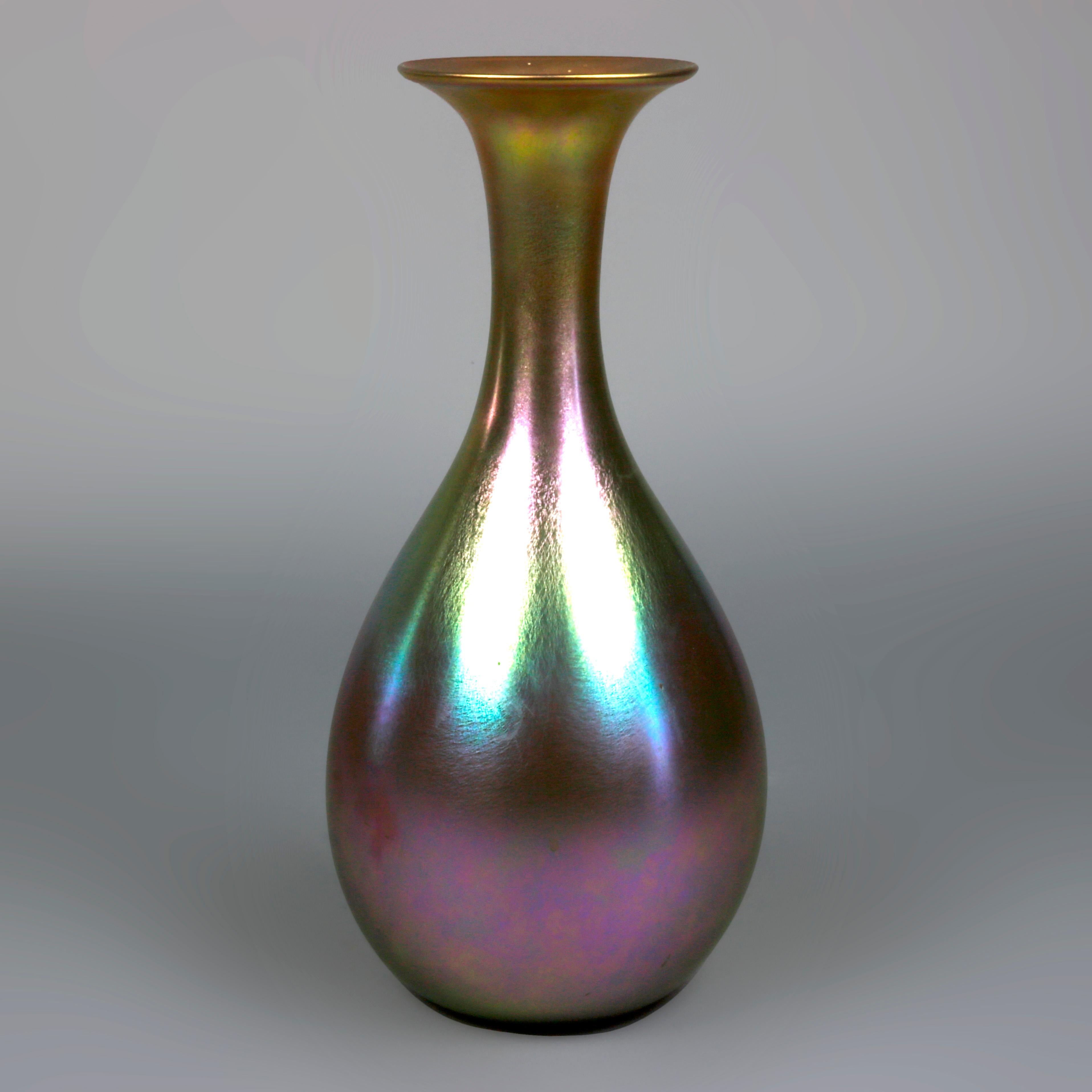 Antique and large Art Nouveau art glass vase by Quezal offers blue, gold, and purple Aurene finish, signed on base as photographed, circa 1900

Measures- 14.88