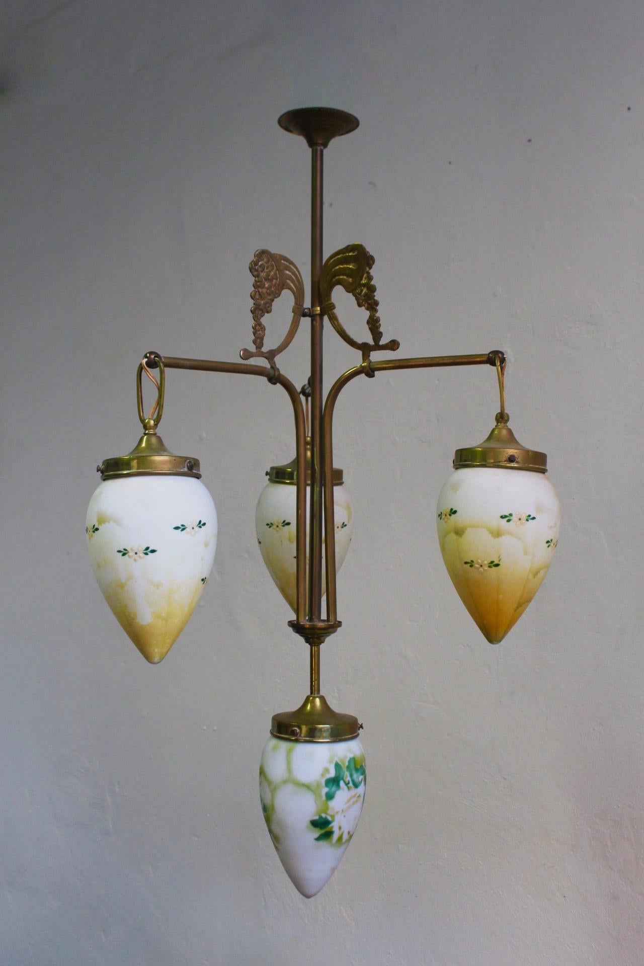 Unique antique Art Nouveau brass chandelier with hand painted milk glass shades, Spain, late 19th century.
The piece remains in good antique condition with wear due to age and use.
 