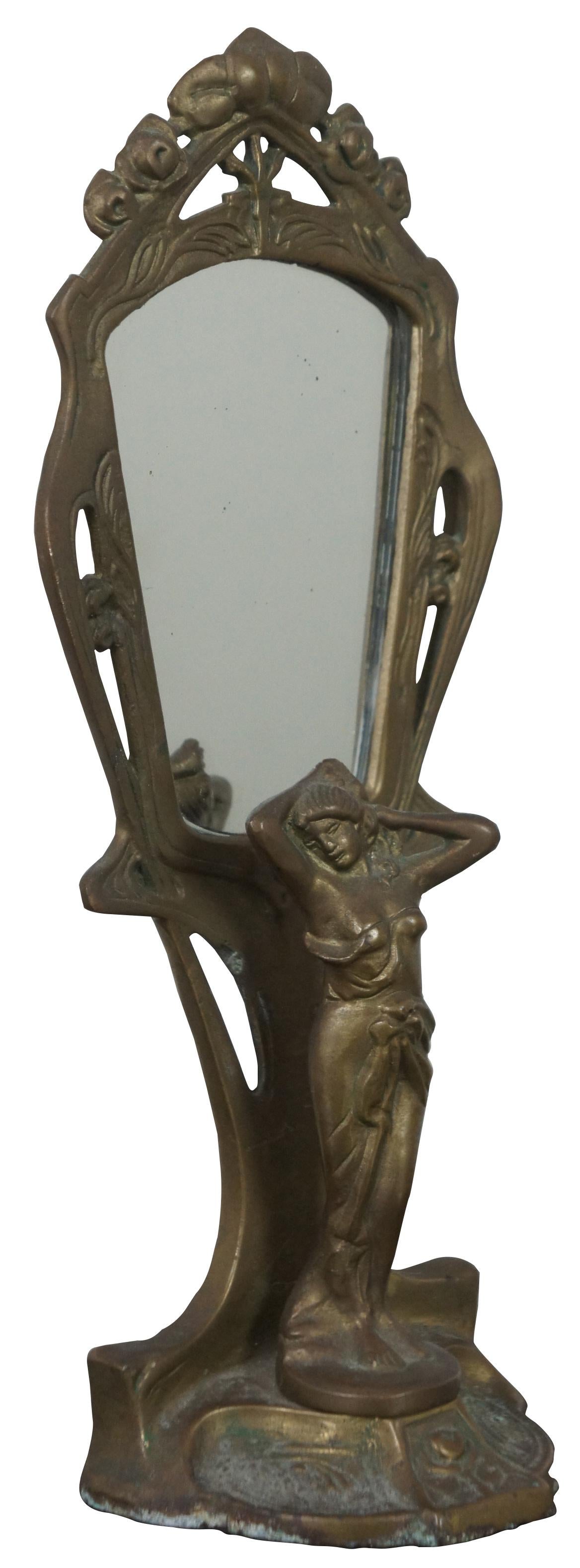 Art Nouveau style, solid brass tabletop mirror with a classical female figure on the base brushing her hair. Measures: 12