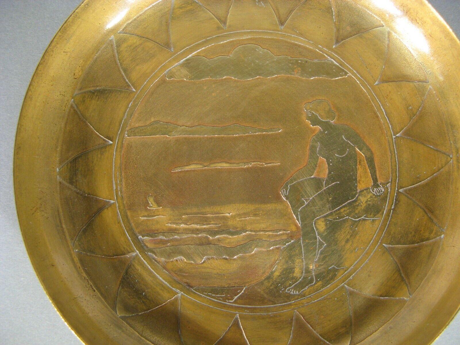 This exquisite trinket dish, crafted in the Art Nouveau style, is made from brass and signed by the renowned artist Jan Joulin. The intricate design features the mythological scene of Ariadne abandoned by Theseus on the island of Naxos, a classic