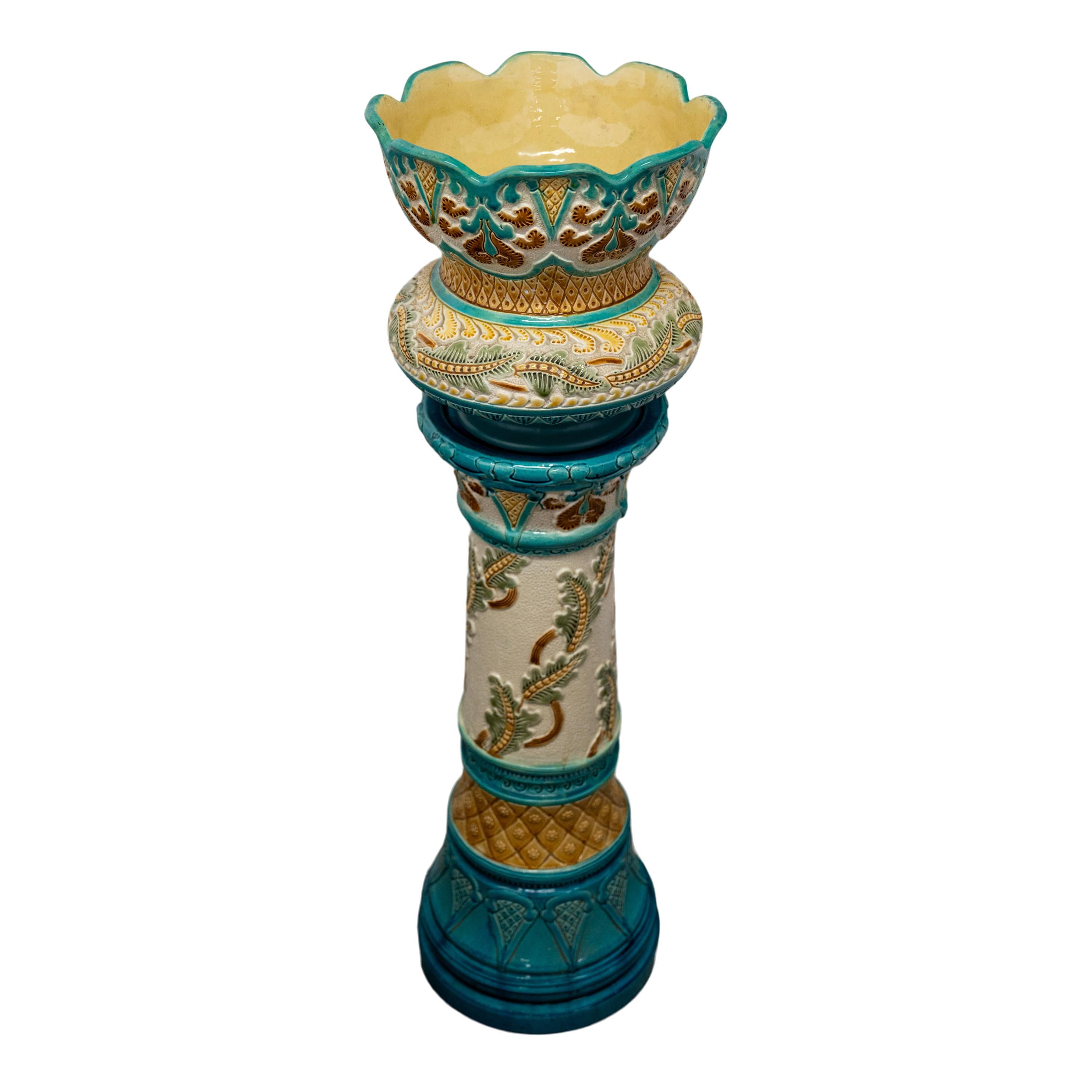 A very handsome Art Nouveau faience pottery jardiniere and Stand, Burmantofts Pottery, circa 1895.
The jardiniere and stand having multi-color glaze and Art Nouveau floral decoration, the base of the jardiniere having incised marks for Burmantofts