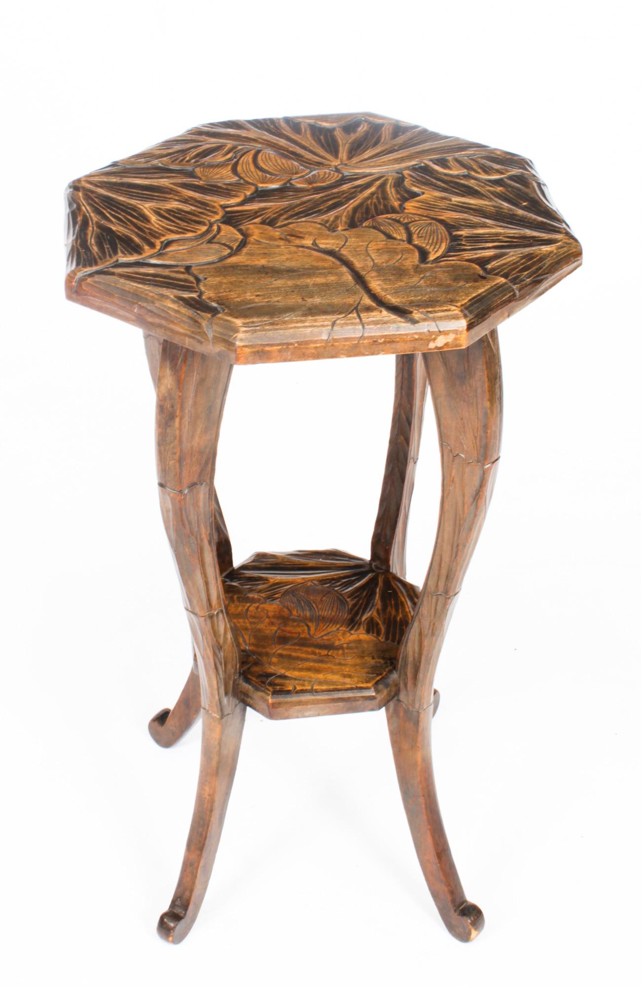 This is a decorative antique Art Nouveau Occasional Table, circa 1900 in date.
 
The octangonal solid walnut shaped top is deeply carved with a leaf motif, on four exaggerated cabriole legs united by a matching undertier.
 
Add some Art Nouveau