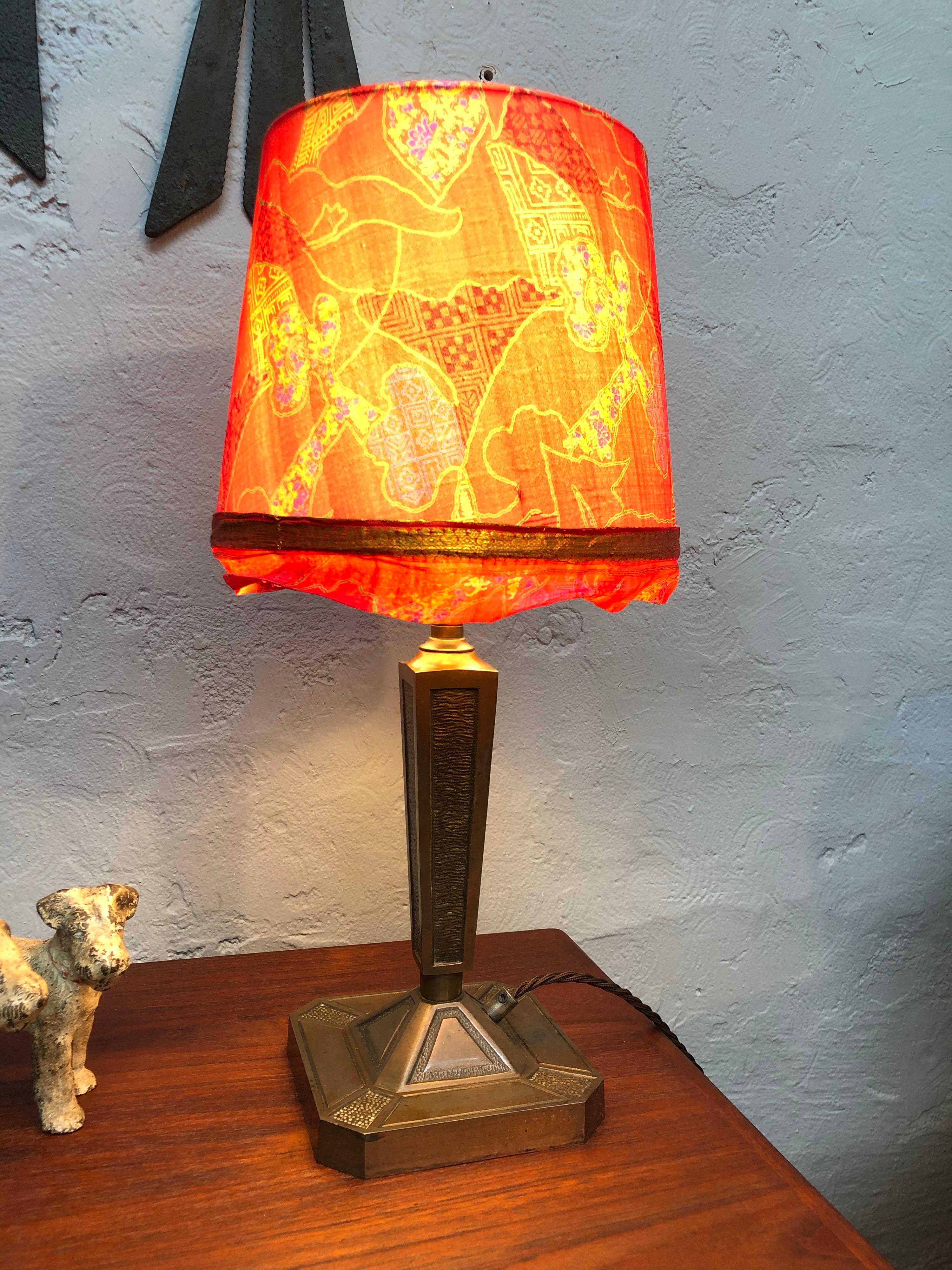 A beautiful well made cast bronze Art Nouveau table lamp. 
In great condition with age related wear and patina. 
Still maintaining its original ceramic and brass lamp holder and also its brass lamp shade holder. 
The lamp has been rewired and