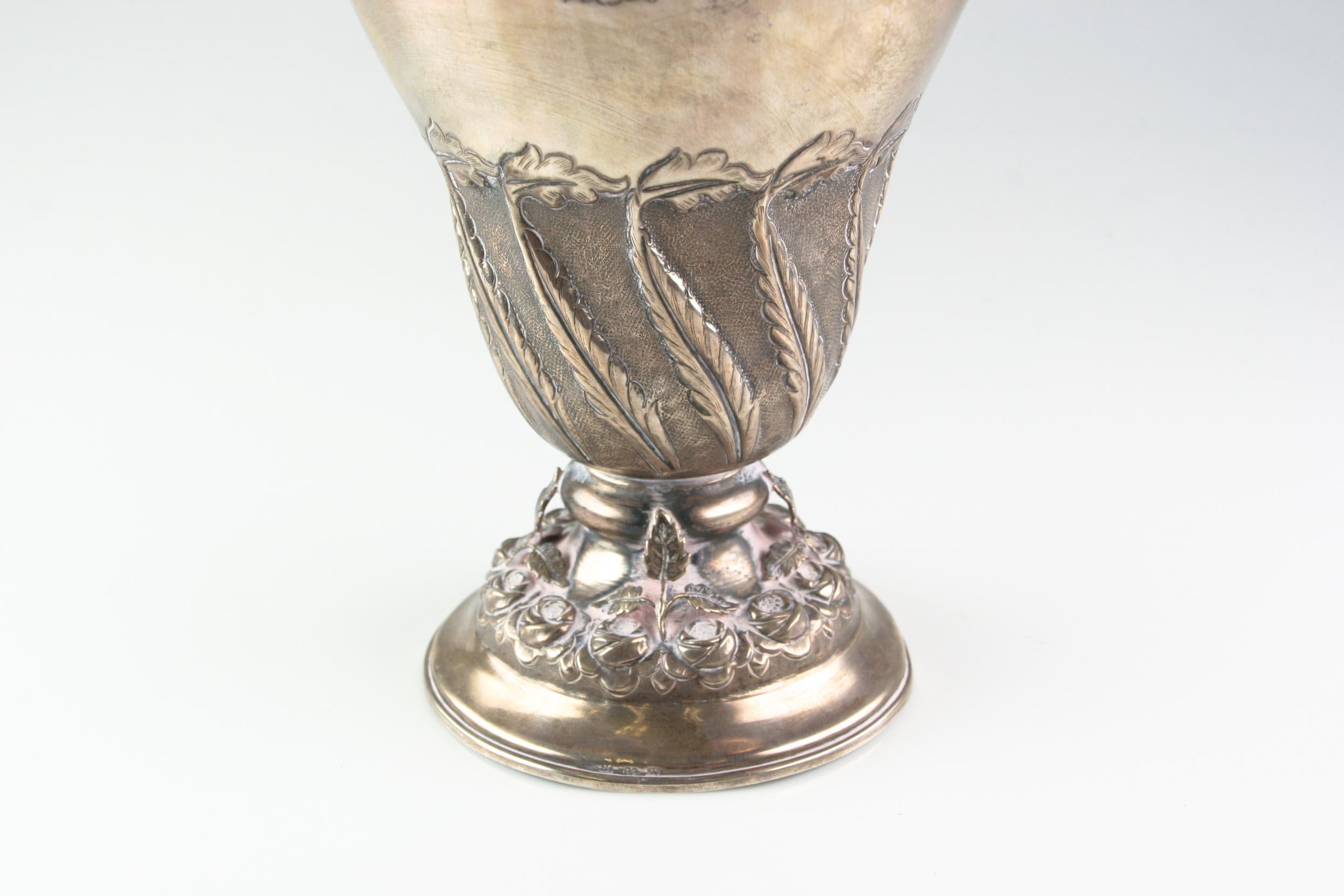 Art Nouveau Design Featuring Naturalistic Fruiting 3-D Vines, Leaves and Roses. Ornate Handle with Cherub seated. 
Ewer water pitcher hand crafted out of 900 Silver
Condition: Over all good condition some old repairs are noticeable on the plate.